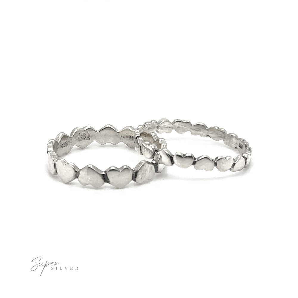 A pair of Hearts Band With Alternating Pattern stacking rings on a white background.