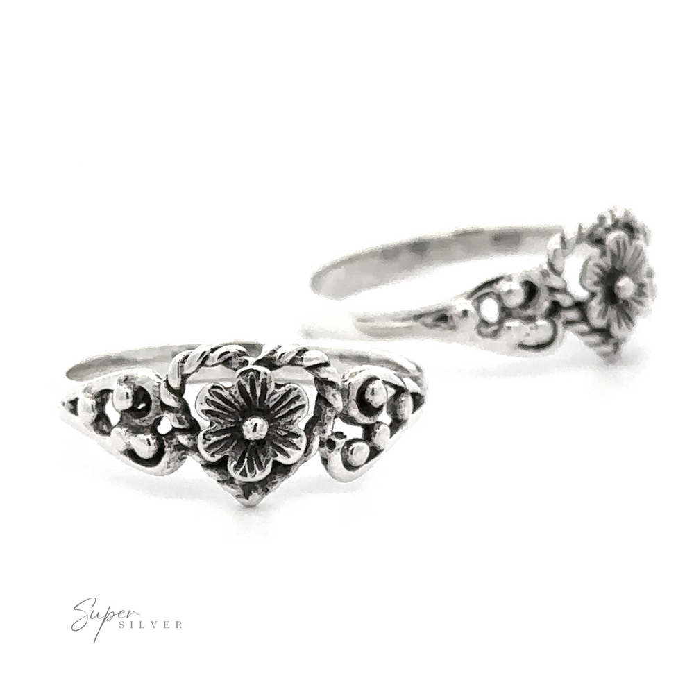Twisted Heart Outline Ring with Floral Detailing displayed against a white background.