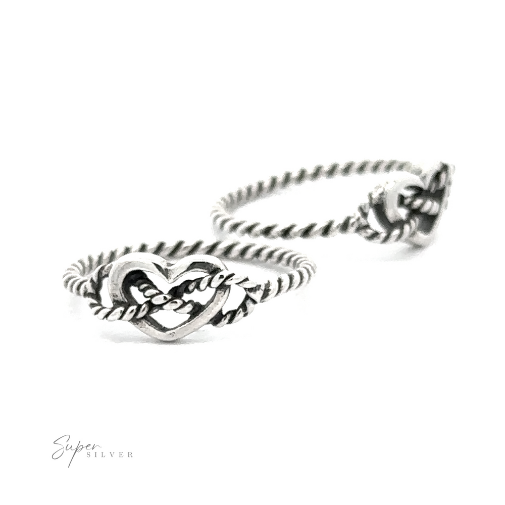 A black and white photograph of a twisted Open Heart Ring With Rope Band featuring an intricate heart design, with the logo 