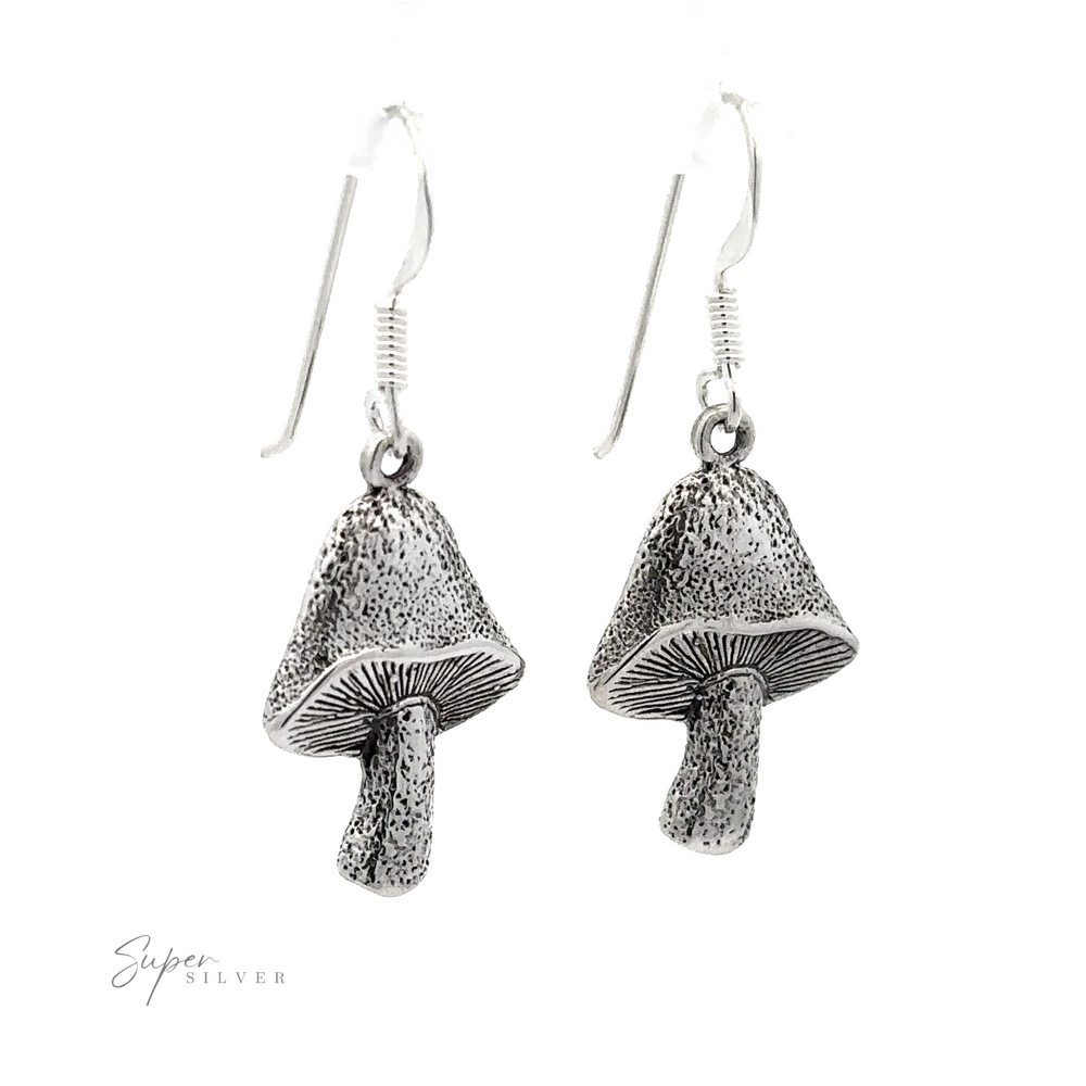 
                  
                    Textured Mushroom Earrings crafted from Sterling Silver with an oxidized finish, detailed texture hanging on simple hooks against a white background.
                  
                