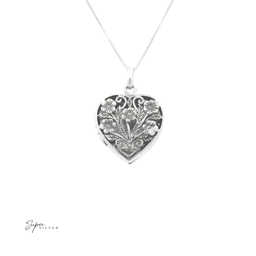 
                  
                    The Floral Heart Shaped Locket is crafted in sterling silver with detailed floral engravings, hanging elegantly from a fine chain against a white background.
                  
                