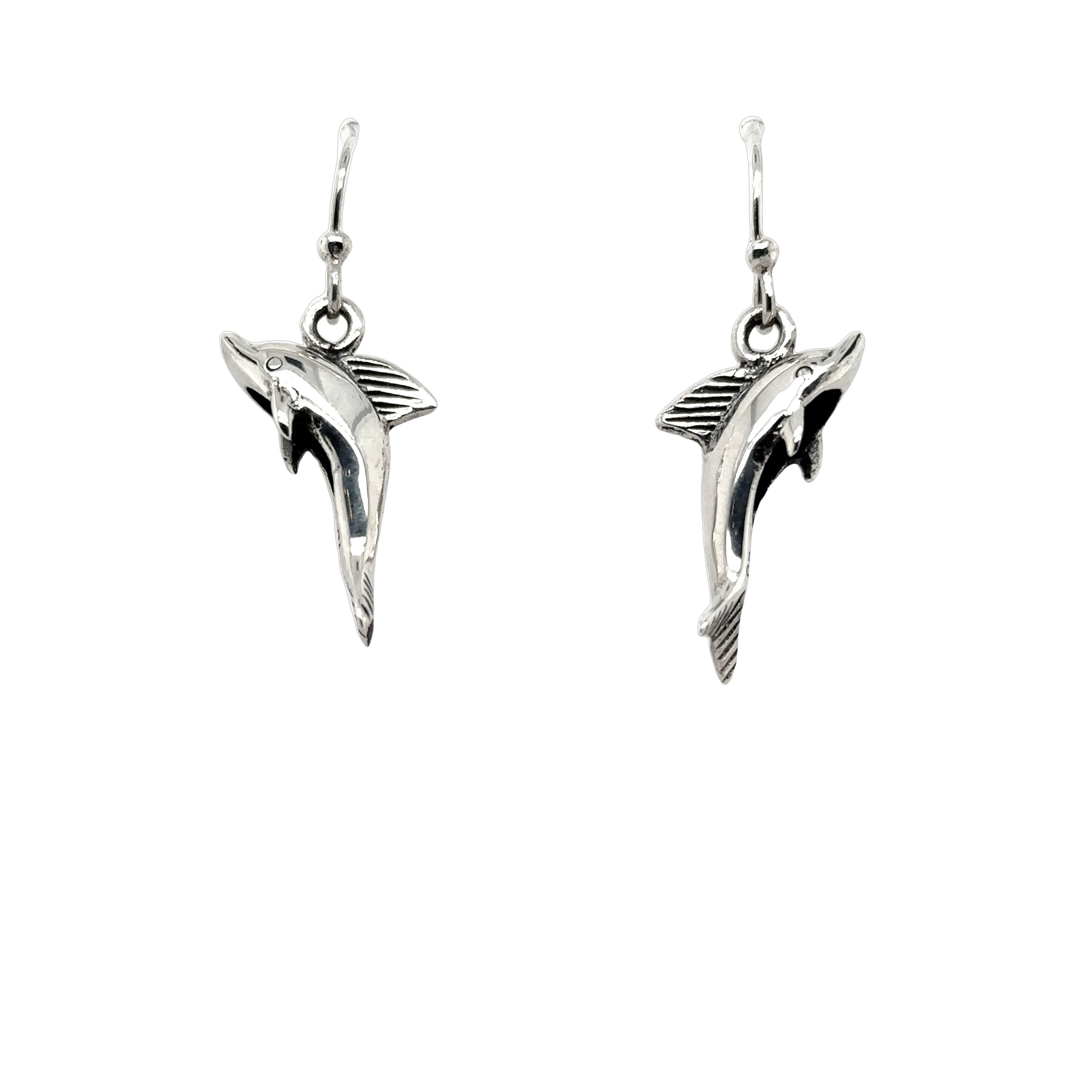 A pair of Super Silver dolphin earrings on a white background.