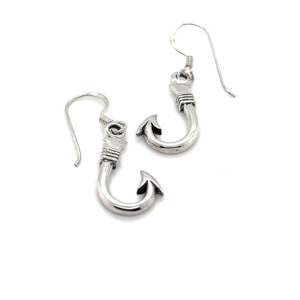 A pair of Fishhook Earrings by Super Silver on a white background.
