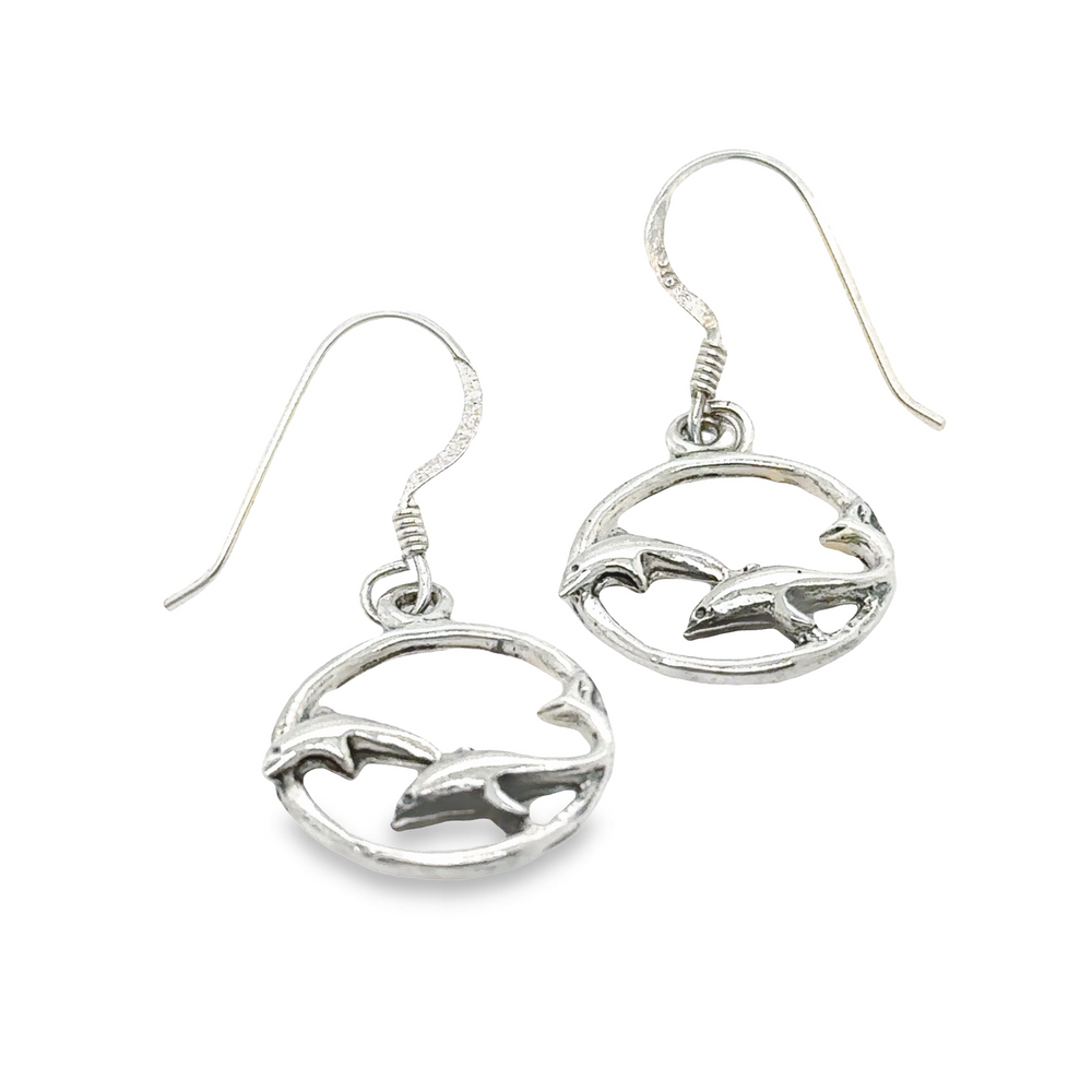 A pair of Super Silver Playful Dolphin Earrings, perfect for ocean lovers.