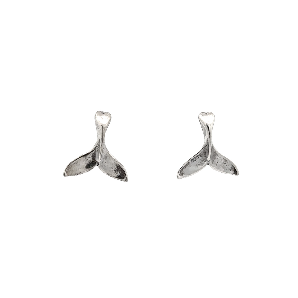 A pair of silver Whale Tail Studs, the perfect ocean-inspired accessory, photographed on a white background.