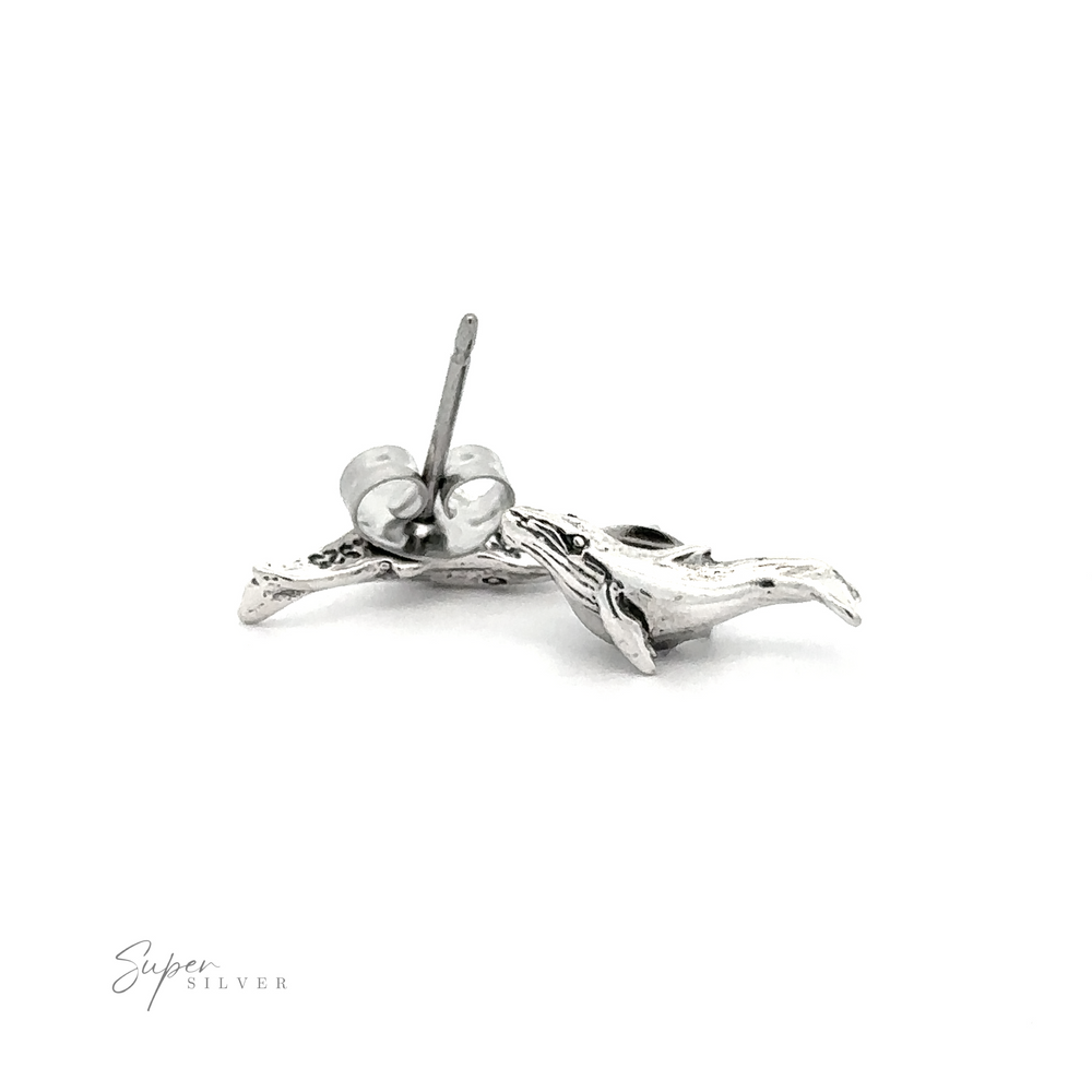A pair of Whale Studs on a white background.