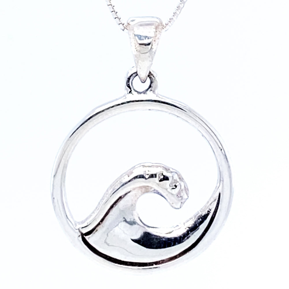 
                  
                    A Serene Wave Pendant set within a circular frame, hanging from a chain, exudes beachy vibes.
                  
                