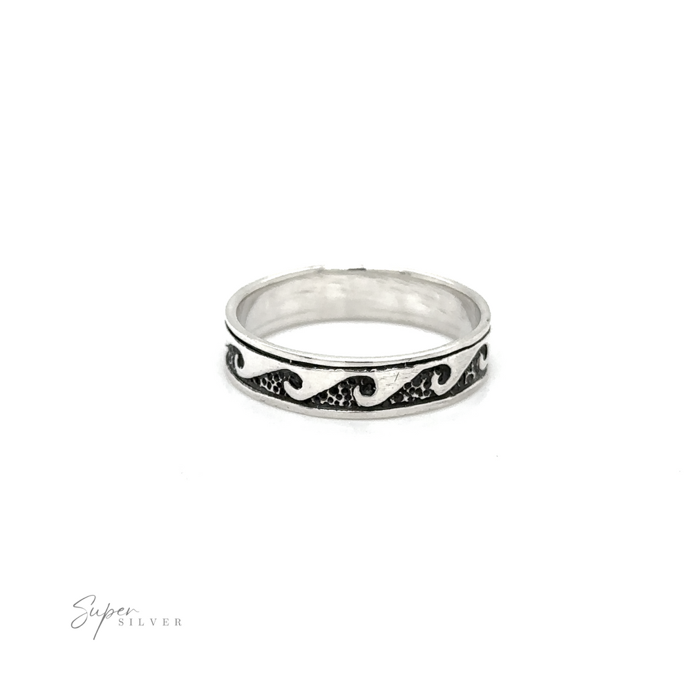 A sterling silver 4mm Wave Band with wave motifs, reminiscent of the ocean.
