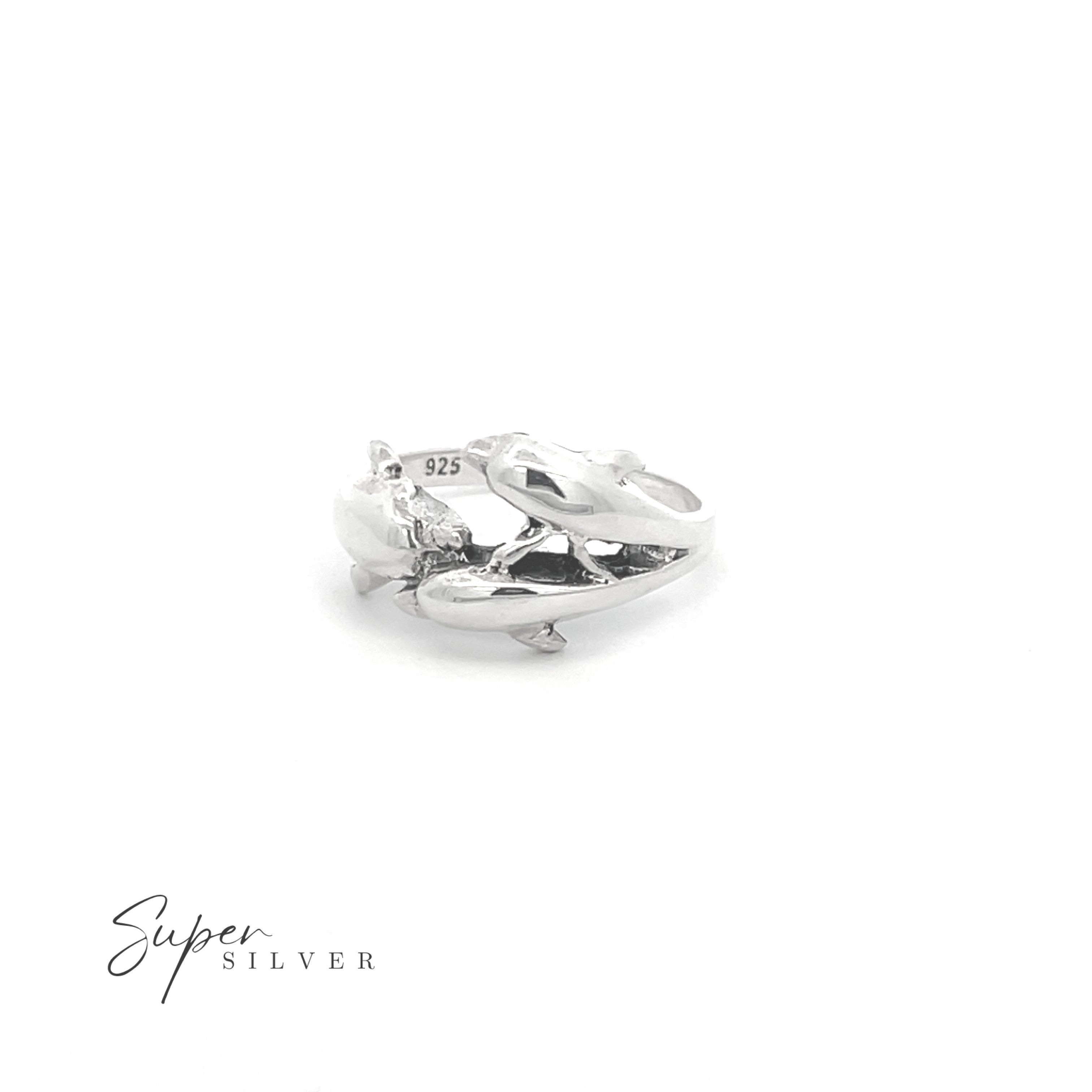 The Dolphin Pod Ring features a sculpted sterling silver dolphin design, marked "925," shown on a white background with the "Super Silver" logo in the bottom left. Perfect jewelry for ocean lovers.