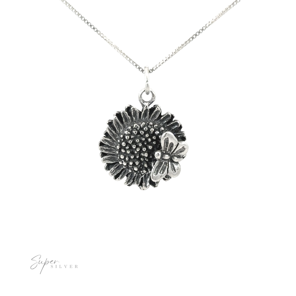 Sunflower charm with butterfly pendant necklace on a white background.