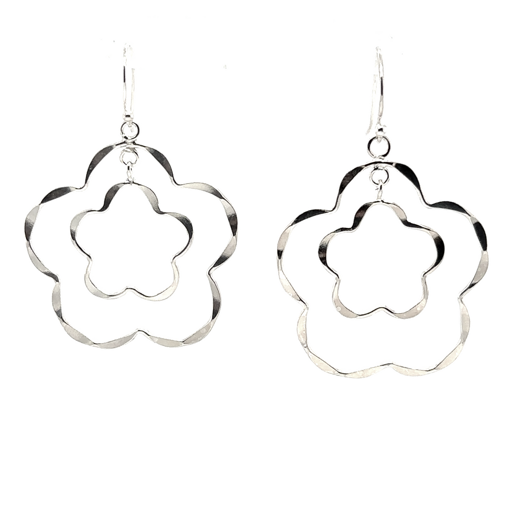 
                  
                    A pair of Super Silver Flower Outline Earrings with a simple texture on a white background.
                  
                