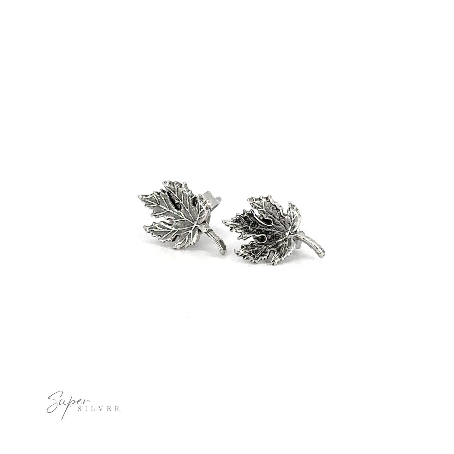 A pair of Maple Leaf Studs on a white background.