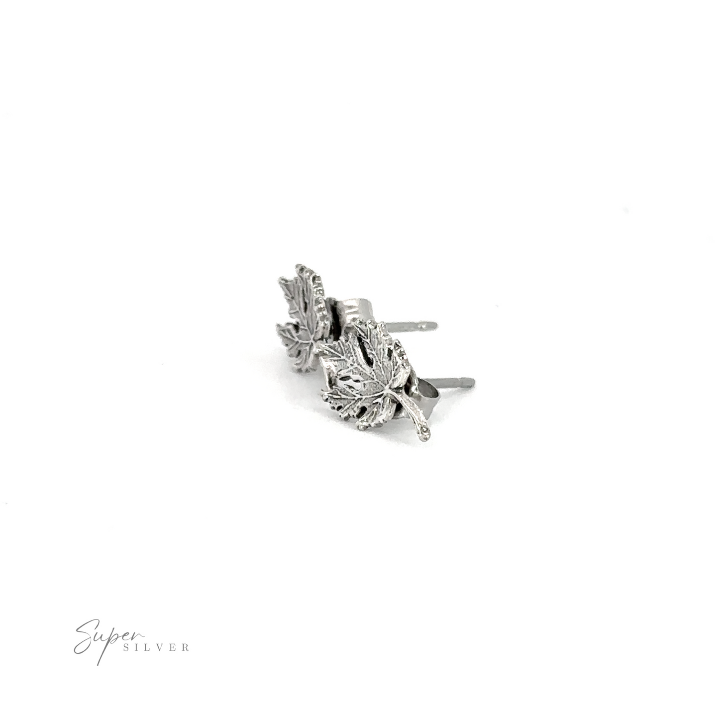 A pair of Maple Leaf Studs on a white background.