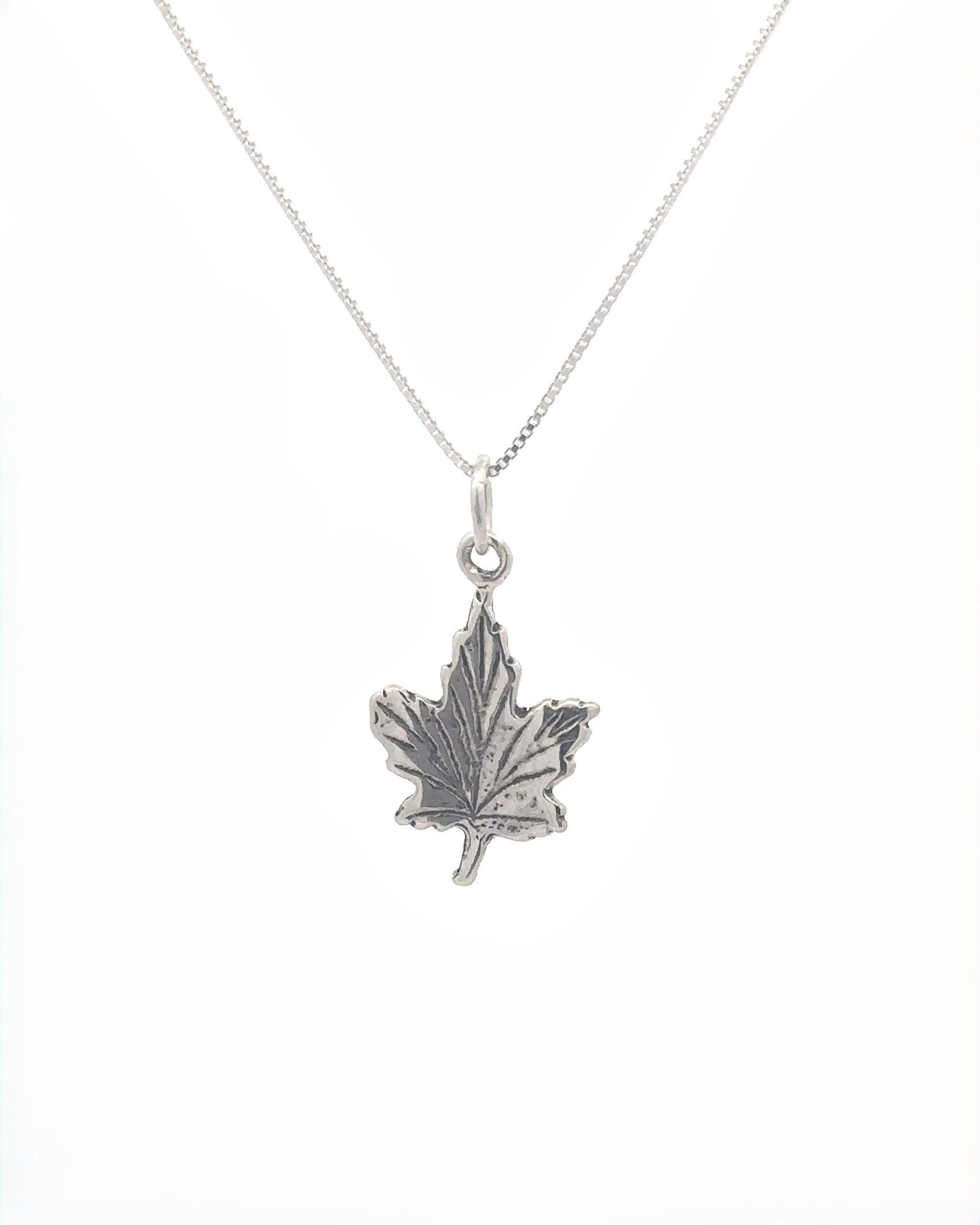 Sterling silver necklace featuring the Tiny Maple Leaf Charm, perfect for embracing autumn style.