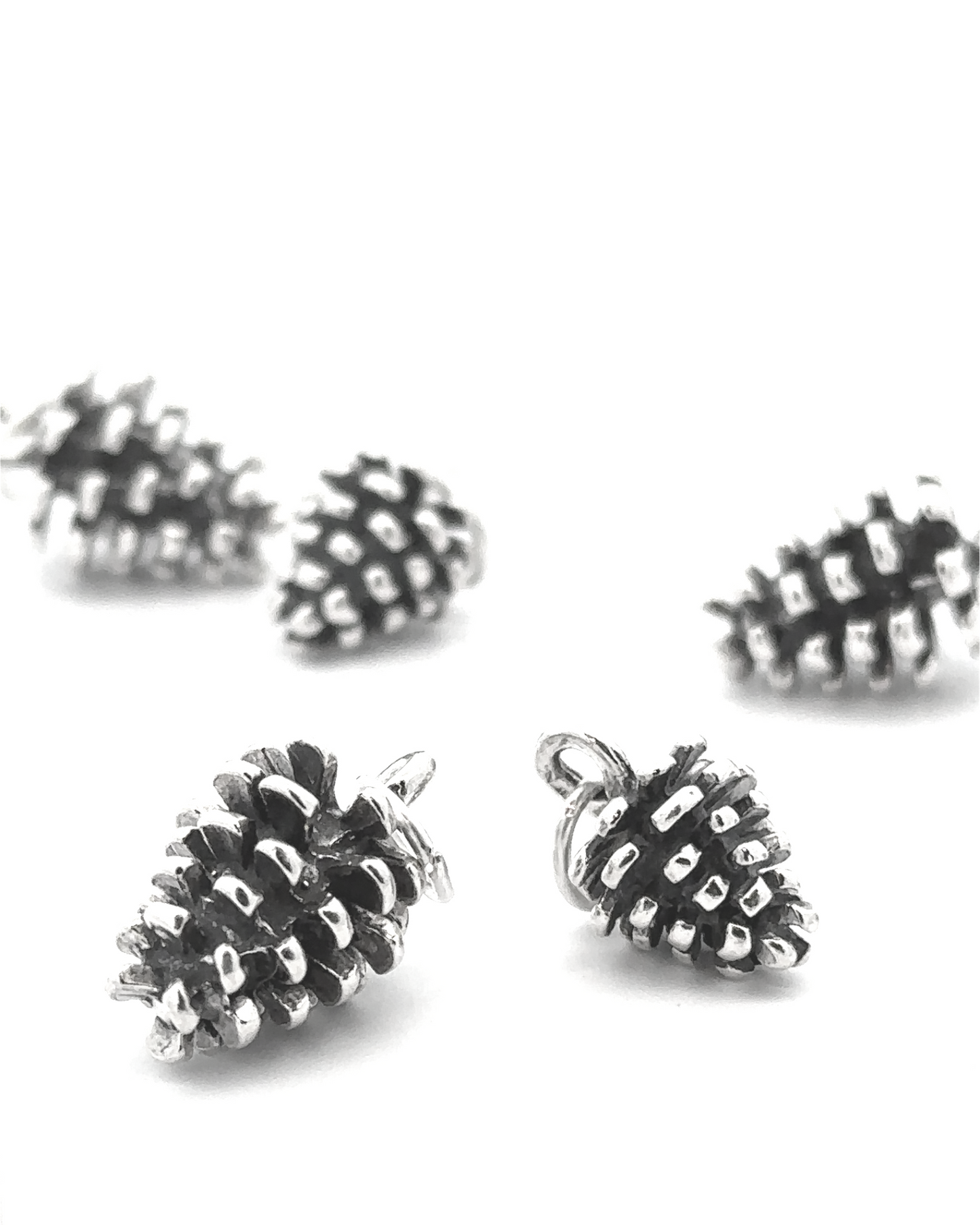 
                  
                    The Pinecone Pendant, designed for nature lovers, shines brilliantly on a white background.
                  
                