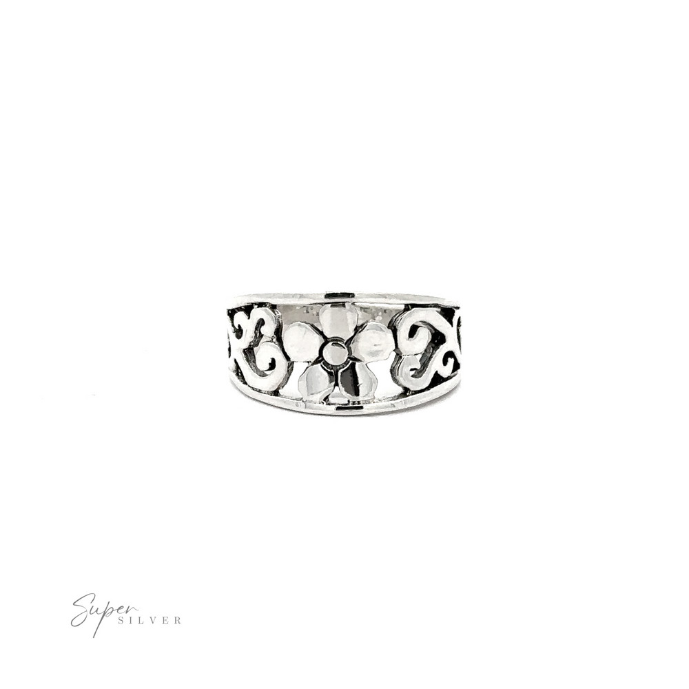 
                  
                    This minimalist Flower Ring With Tapered Band and Swirls features a silver floral design on a tapered band.
                  
                