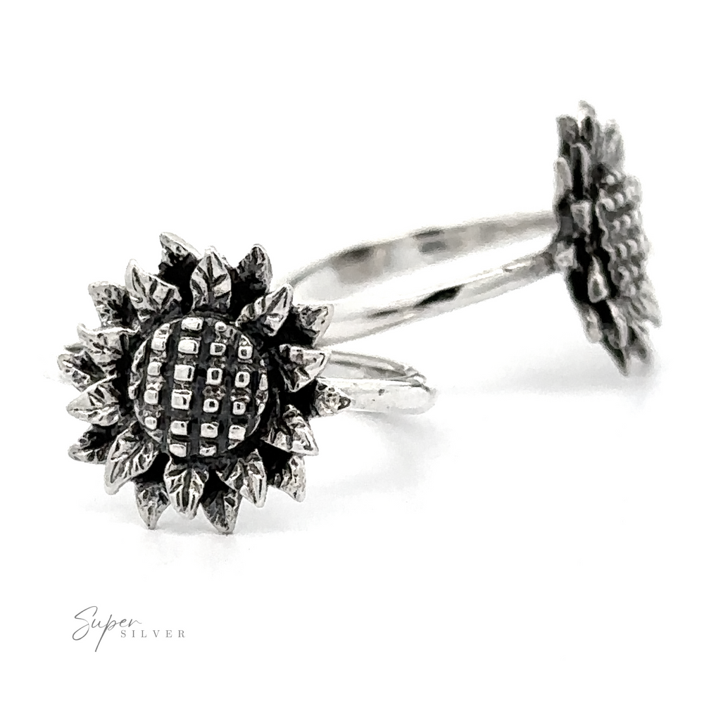 A Silver Sunflower Ring with a detailed petal design and a textured center, displayed against a white background.