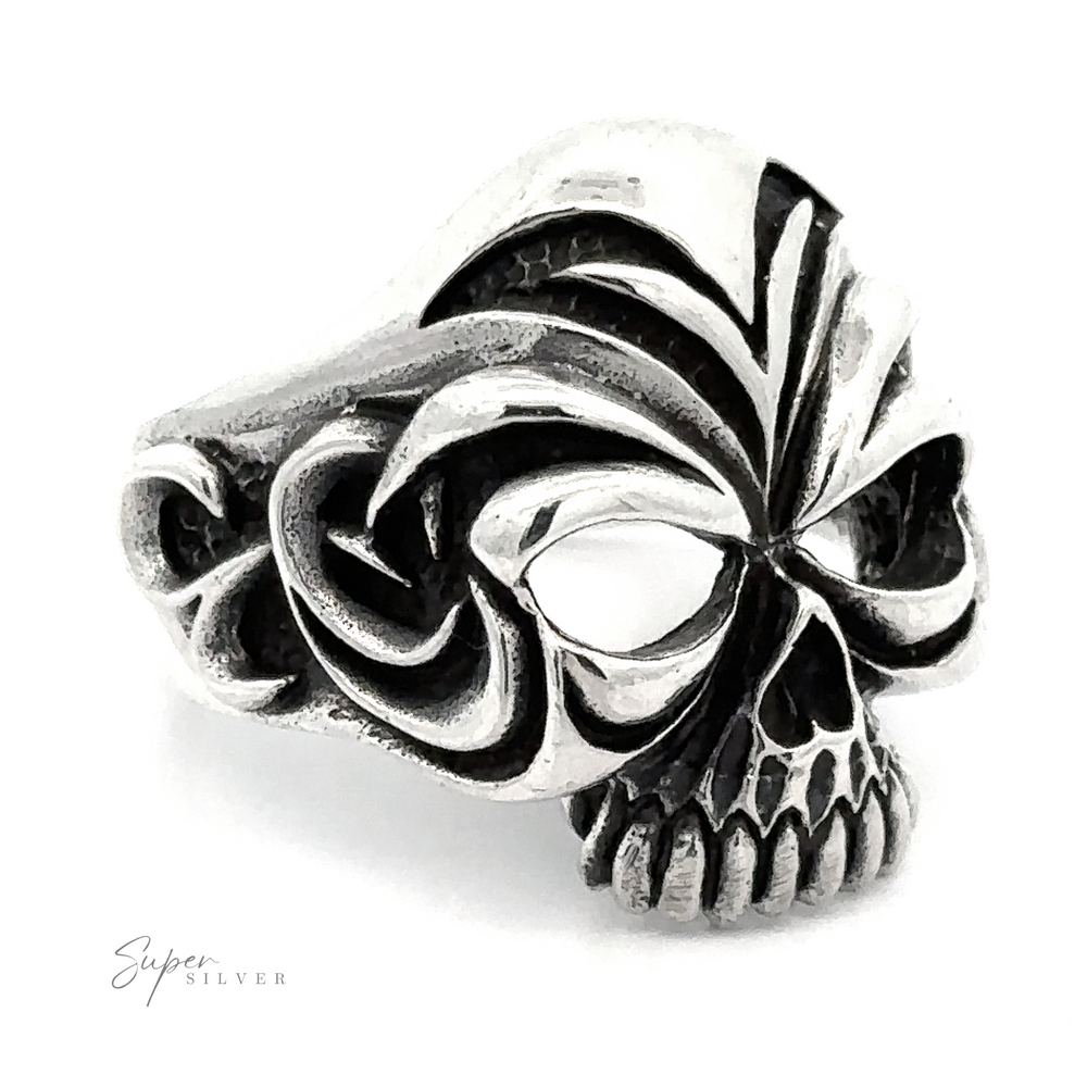 A detailed, Large Carved Skull Ring with intricate black engravings. The design features large eye sockets and prominent teeth at the front, embodying a bold style. The words 