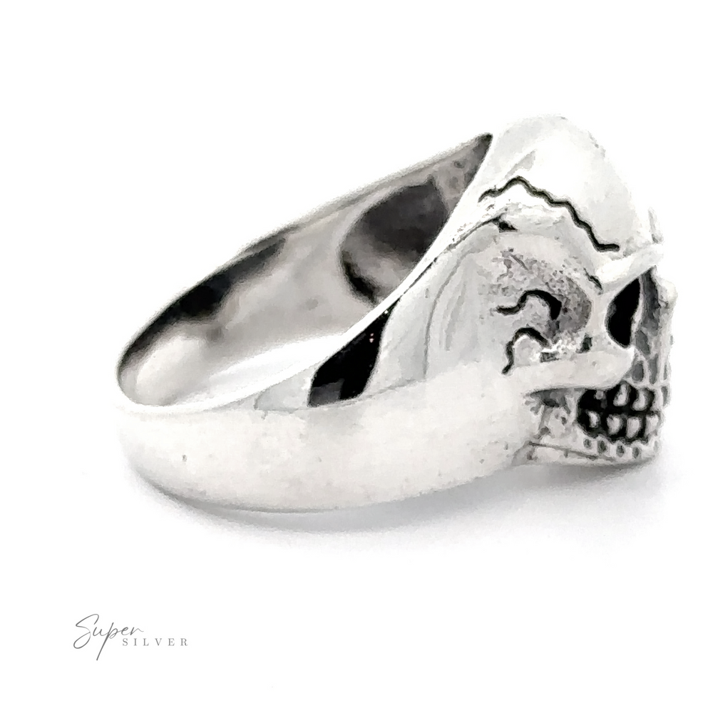 
                  
                    A polished .925 Sterling Silver ring featuring an intricately designed, veined skull, with decorative engravings on the forehead and a hollowed-out eye socket. This bold accessory displays the words "Detailed Veined Skull Statement Ring" in the bottom corner.
                  
                