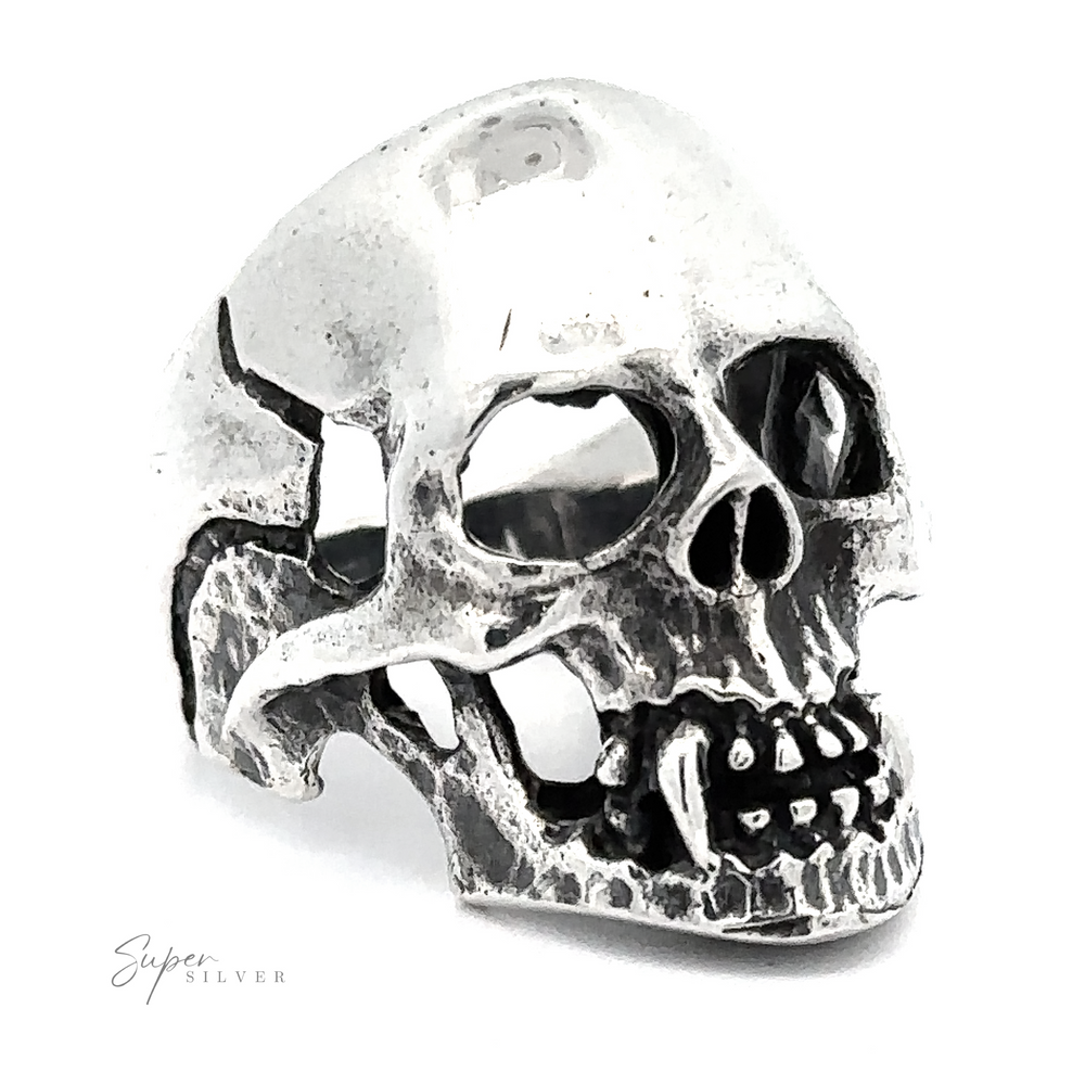 A Large Fanged Skull Statement Ring designed with a gothic aesthetic, featuring detailed eye sockets, teeth, and jaw. The brand name "Super Silver" is inscribed at the bottom left.