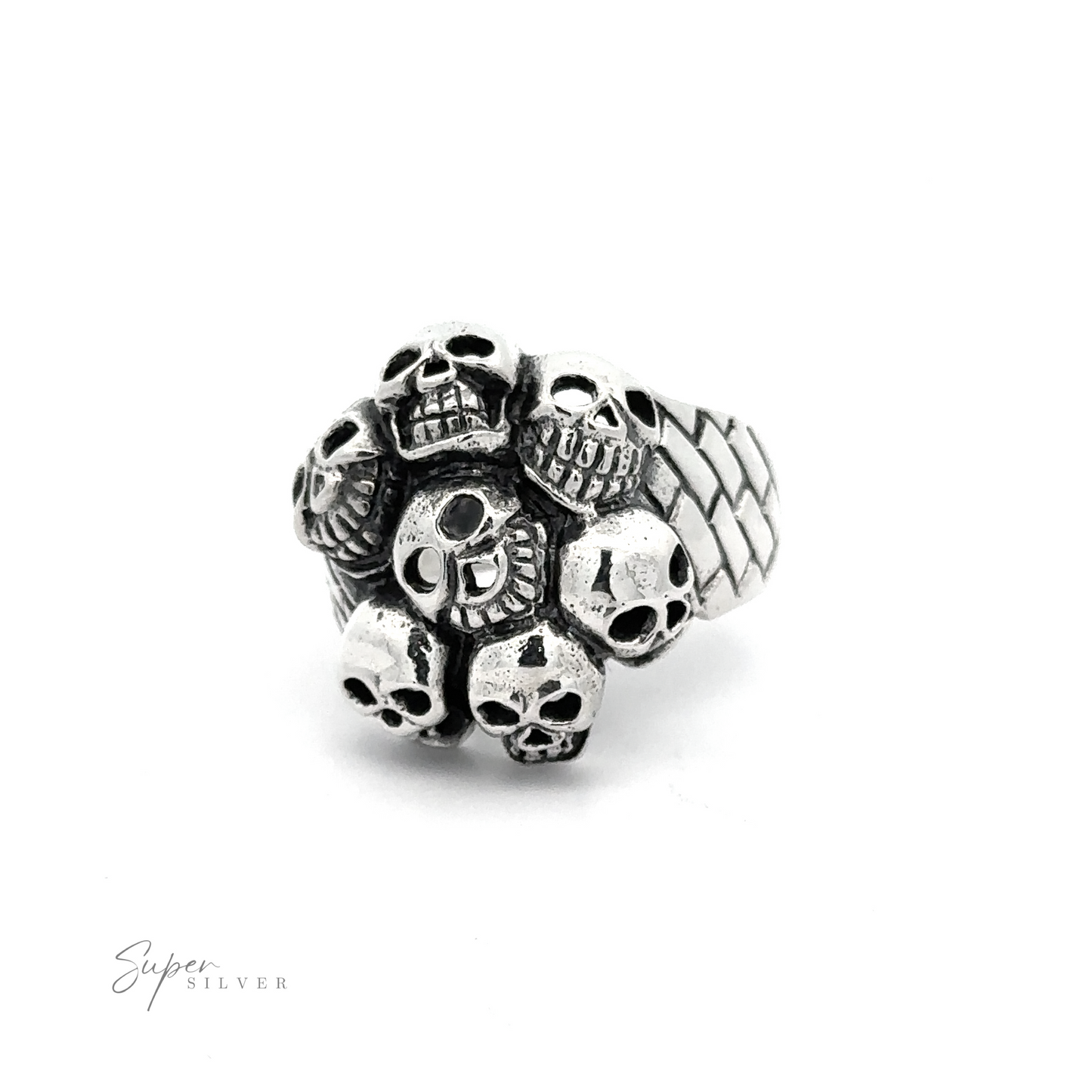 A Seven Grinning Skulls Ring featuring a cluster of small skulls on the band, displayed against a plain white background. The distinctive style and unique craftsmanship make it stand out. The brand “Super Silver” is noted in the bottom left corner.