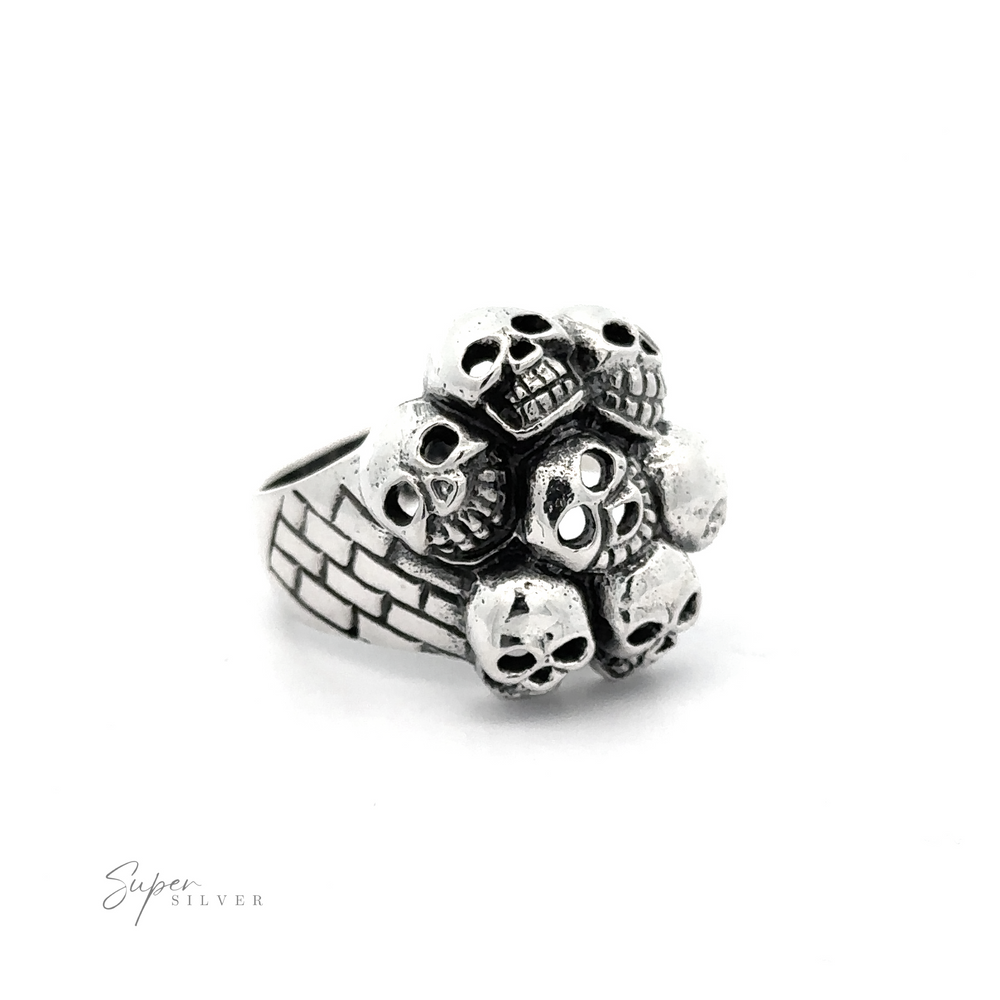 
                  
                    A Seven Grinning Skulls Ring showcasing an arrangement of small skulls on top. The band features a brick-like pattern, embodying unique craftsmanship and distinctive style.
                  
                