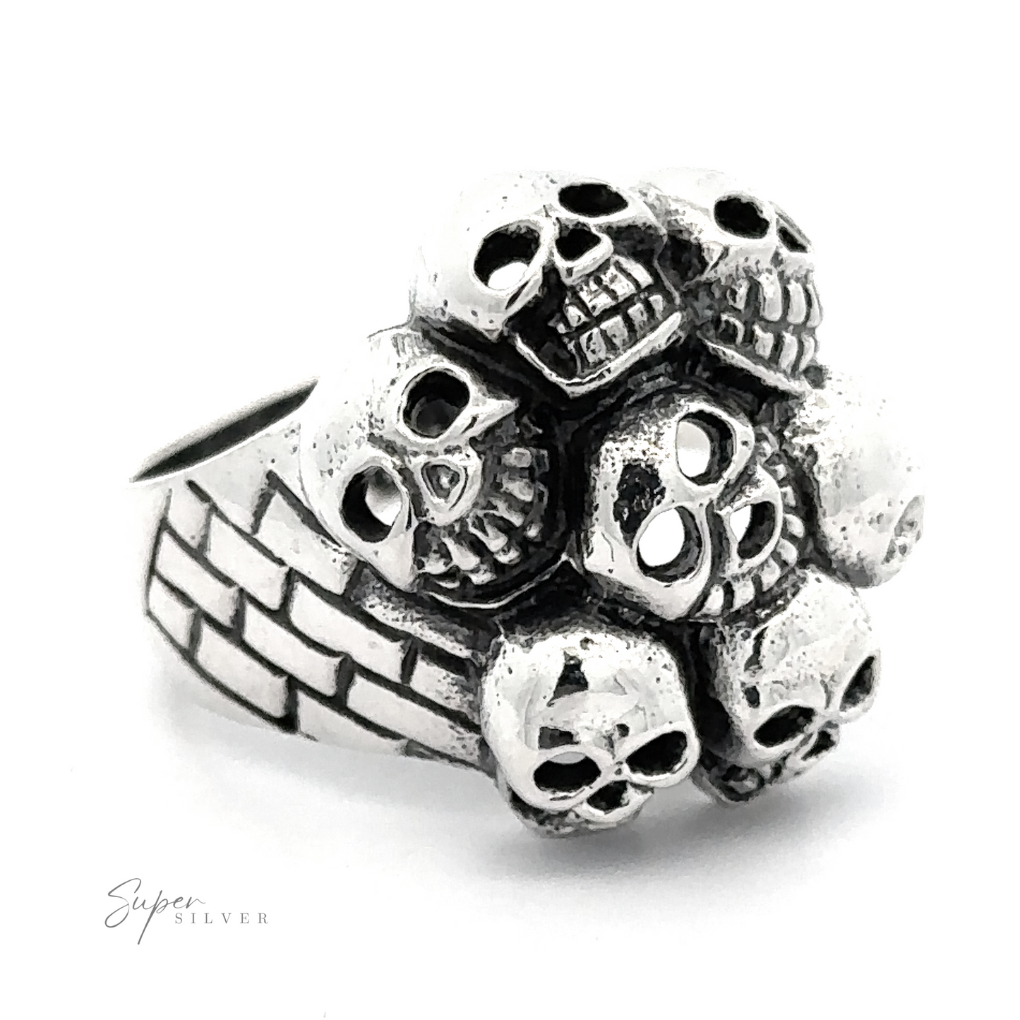 A Seven Grinning Skulls Ring, featuring a cluster of intricately detailed skulls on the front. The band has a textured pattern, showcasing unique craftsmanship and distinctive style.