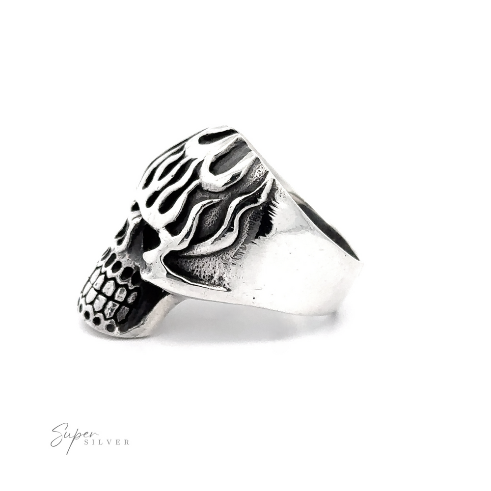 
                  
                    Flaming Skull Statement Ring in the shape of a skull with flame details, crafted from .925 Sterling Silver. The "Super Silver" logo is present in the bottom left corner.
                  
                