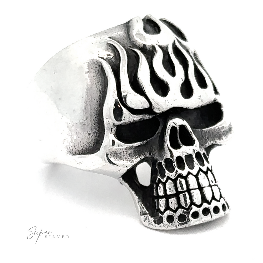 A Flaming Skull Statement Ring featuring an intricately designed skull with flame patterns on its head.