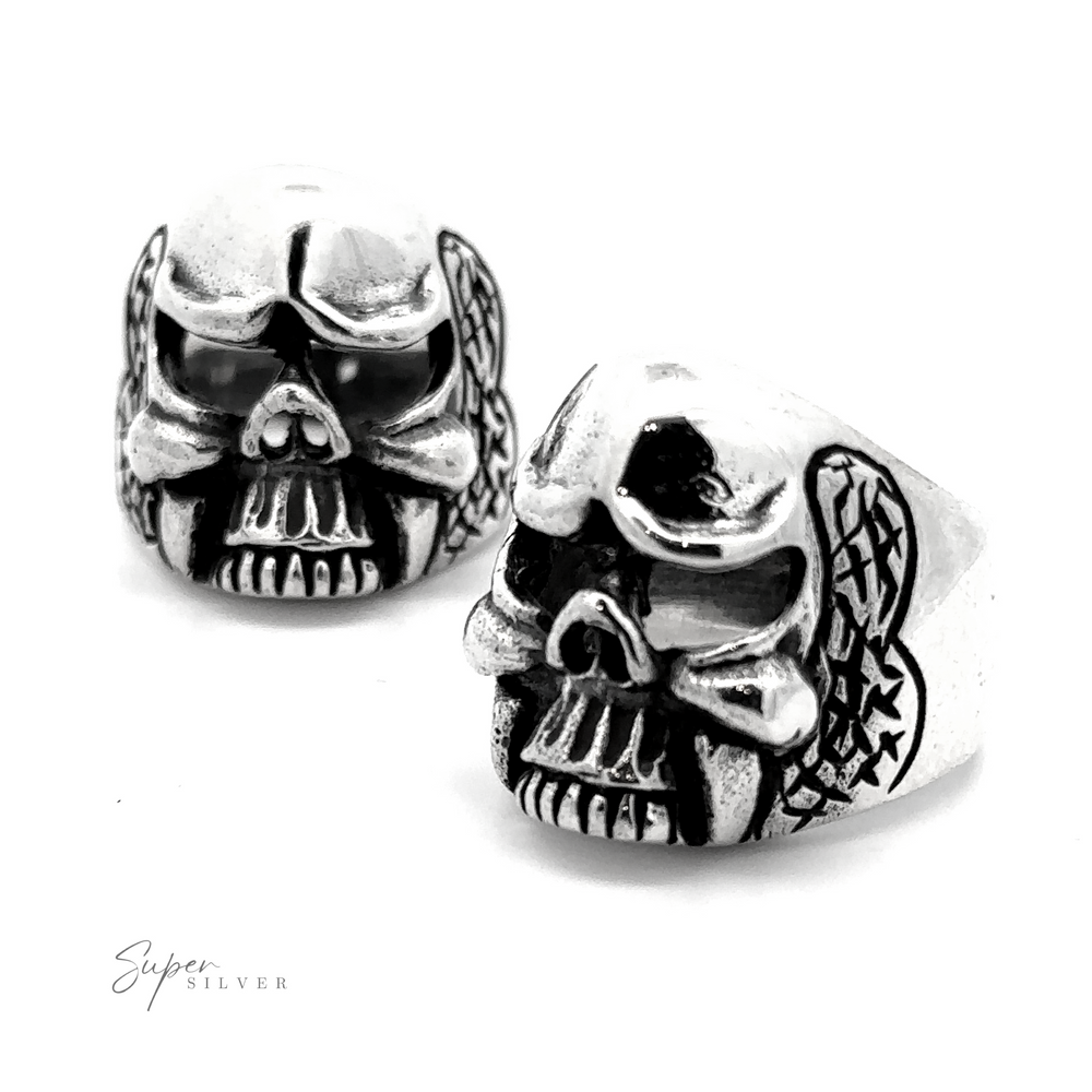 Two silver Skull Statement Rings with intricately designed skulls and wing motifs on the sides, showcasing an edgy style against a plain white background. Made from .925 Sterling Silver, the brand name "Super Silver" is visible in the lower-left corner.