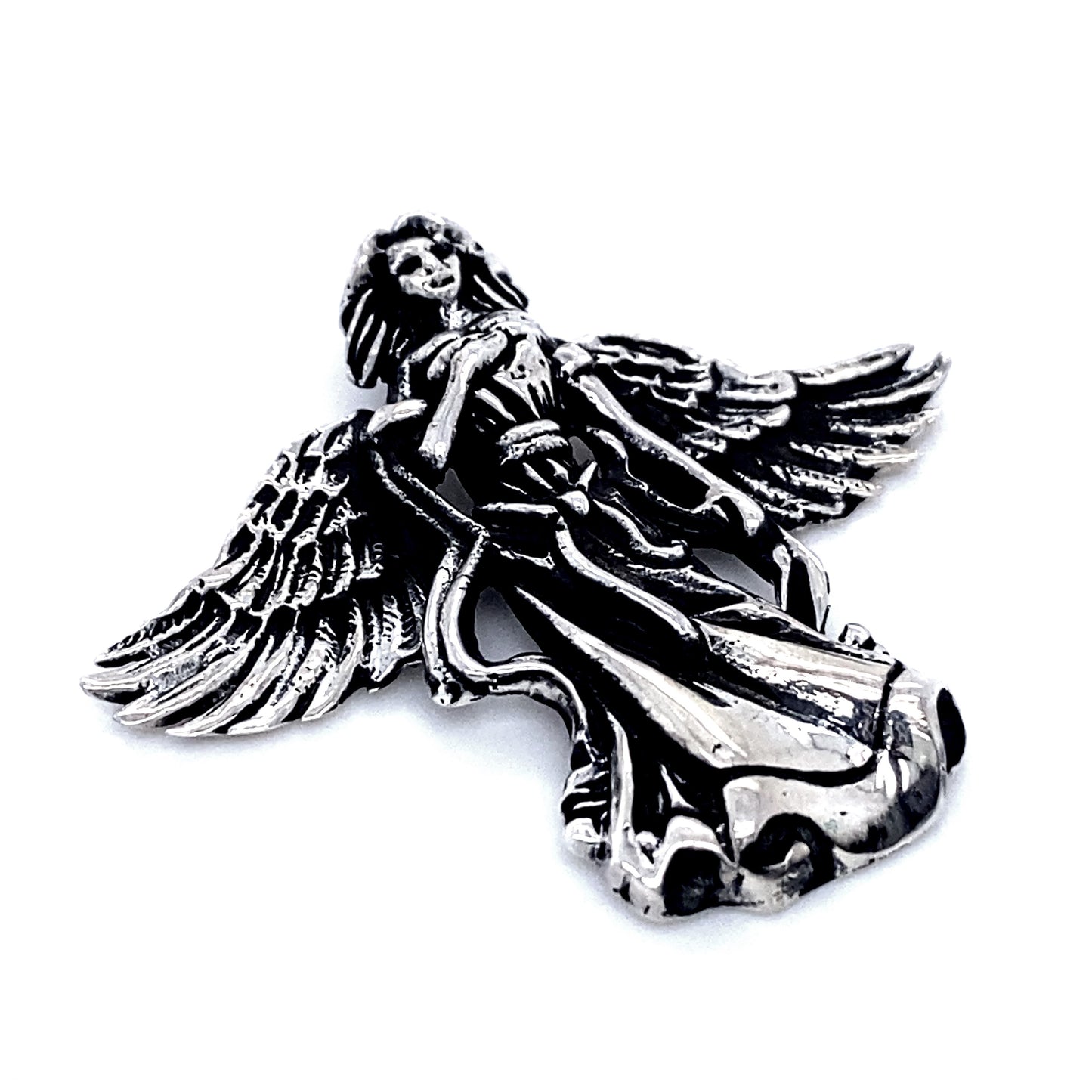 An intricately carved Flowing Angel Pendant With Hand Over Heart with detailed wings and flowing robe, showcasing antiqued detailing, is shown against a white background.