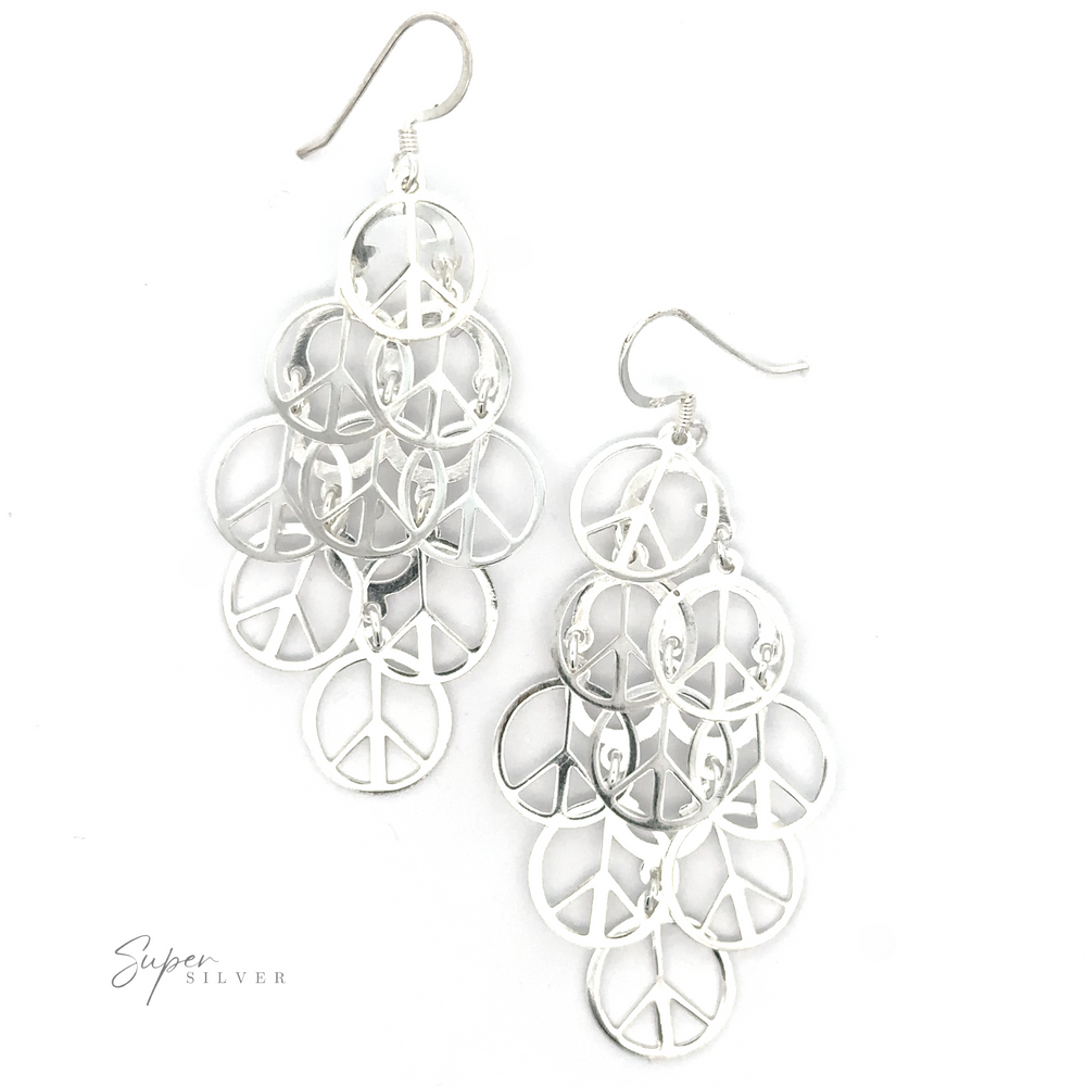 A pair of intricate silver filigree Layered Peace Sign Earrings displayed on a white background.