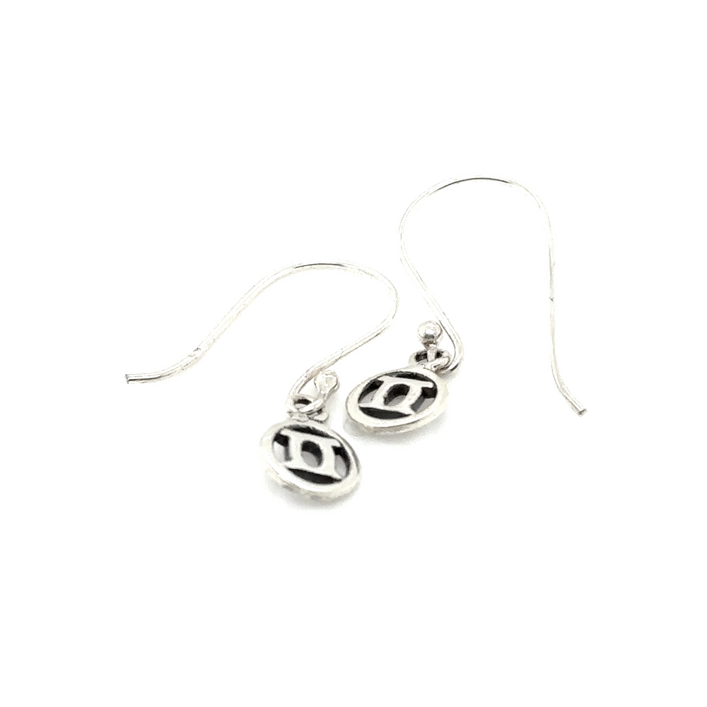 A pair of Super Silver Gemini Zodiac Earrings with a circle featuring the Gemini Zodiac symbol.