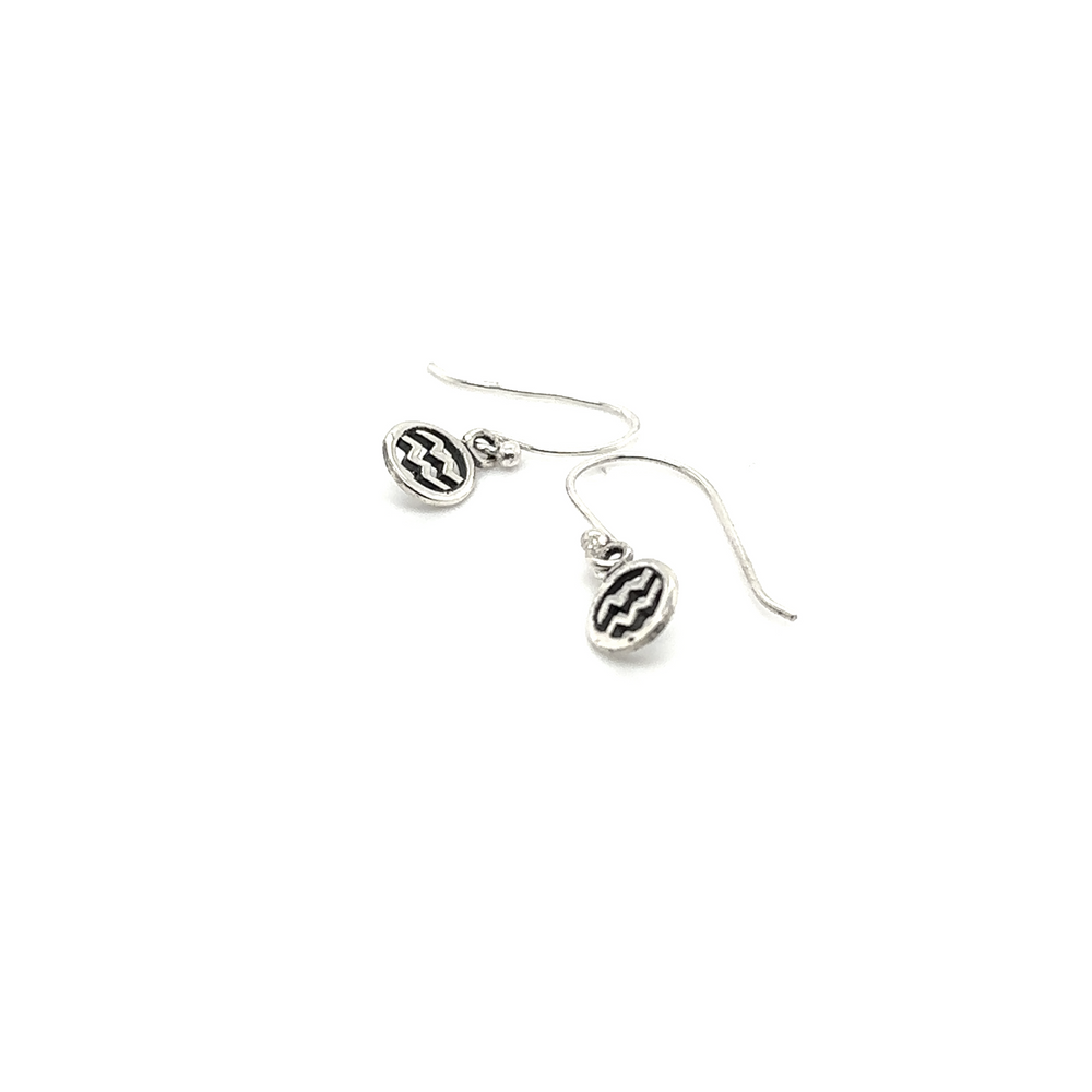 
                  
                    A pair of Aquarius Zodiac Earrings by Super Silver with a black and white design.
                  
                