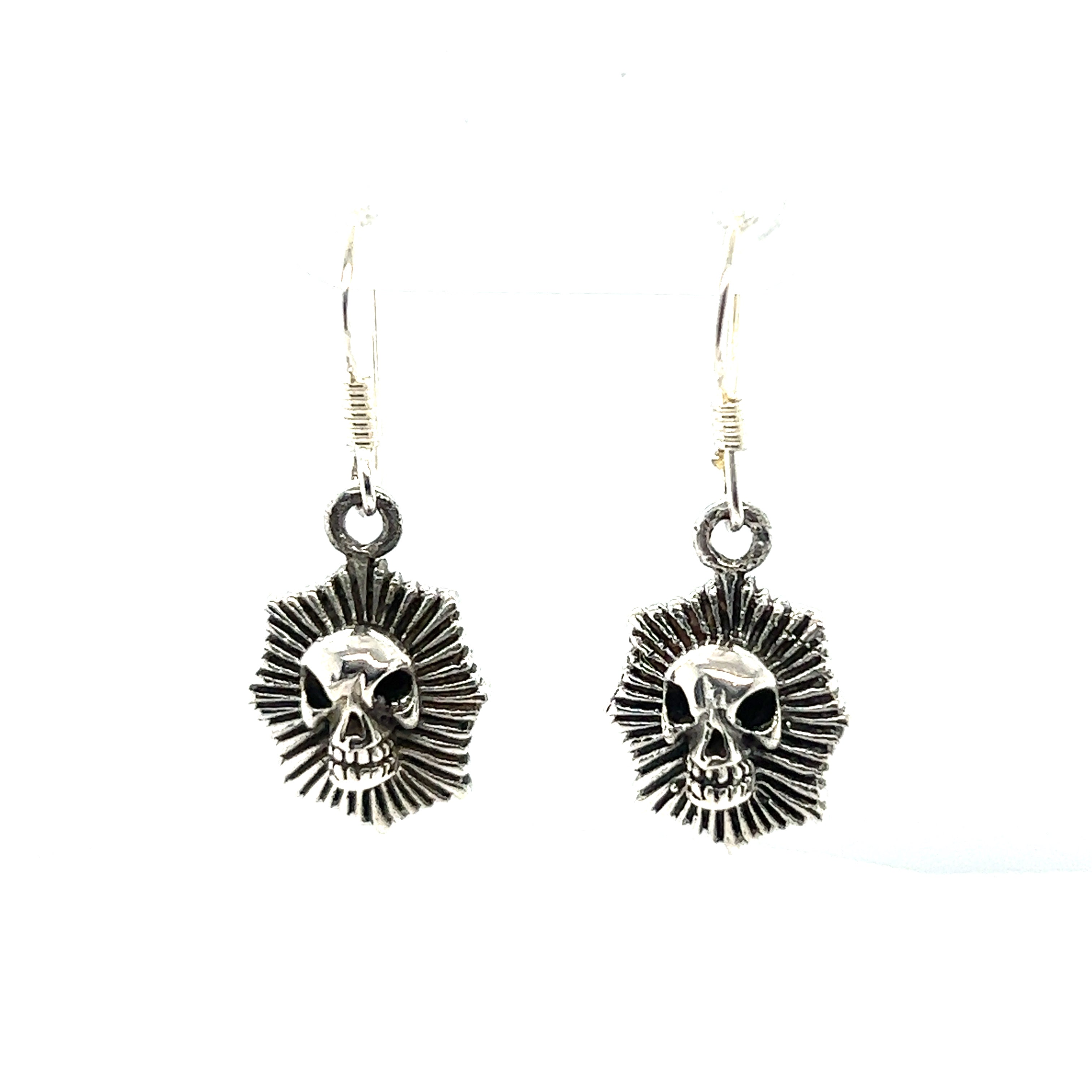 A pair of Super Silver Radiant Skull Earrings with an edgy and elegant sunburst design, exuding mystique.