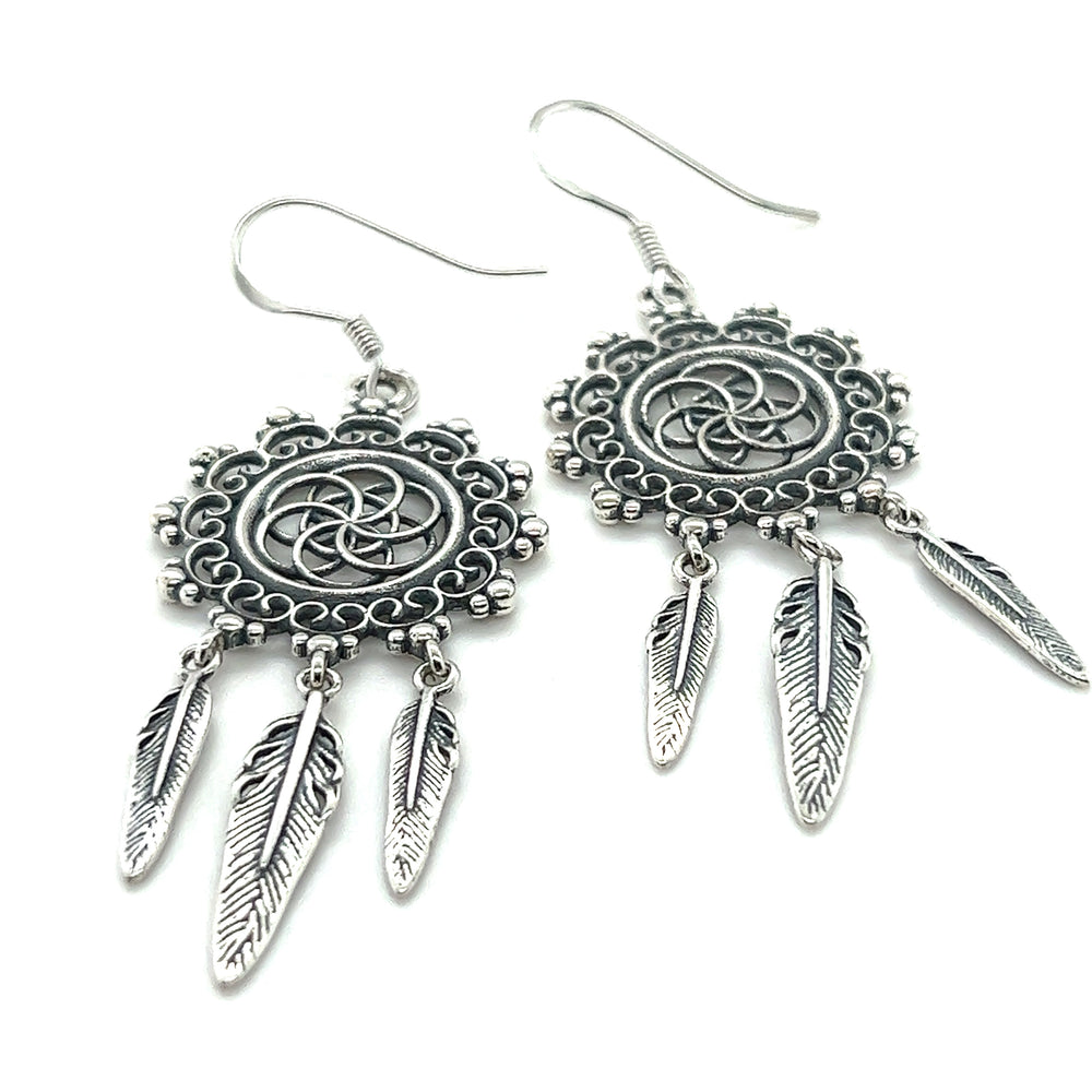 
                  
                    A pair of Super Silver dreamcatcher earrings with feathers, perfect for the bohemian soul.
                  
                