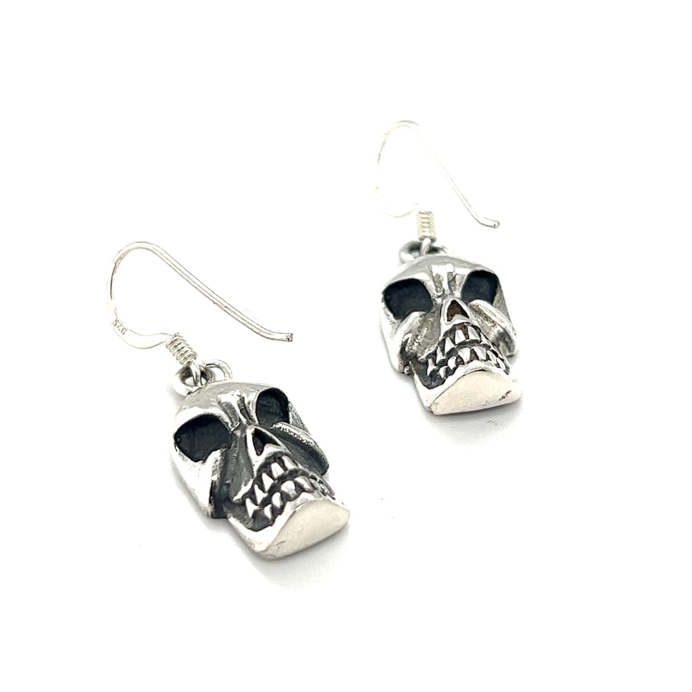 
                  
                    A pair of Super Silver skull earrings with an alternative style on a white background.
                  
                
