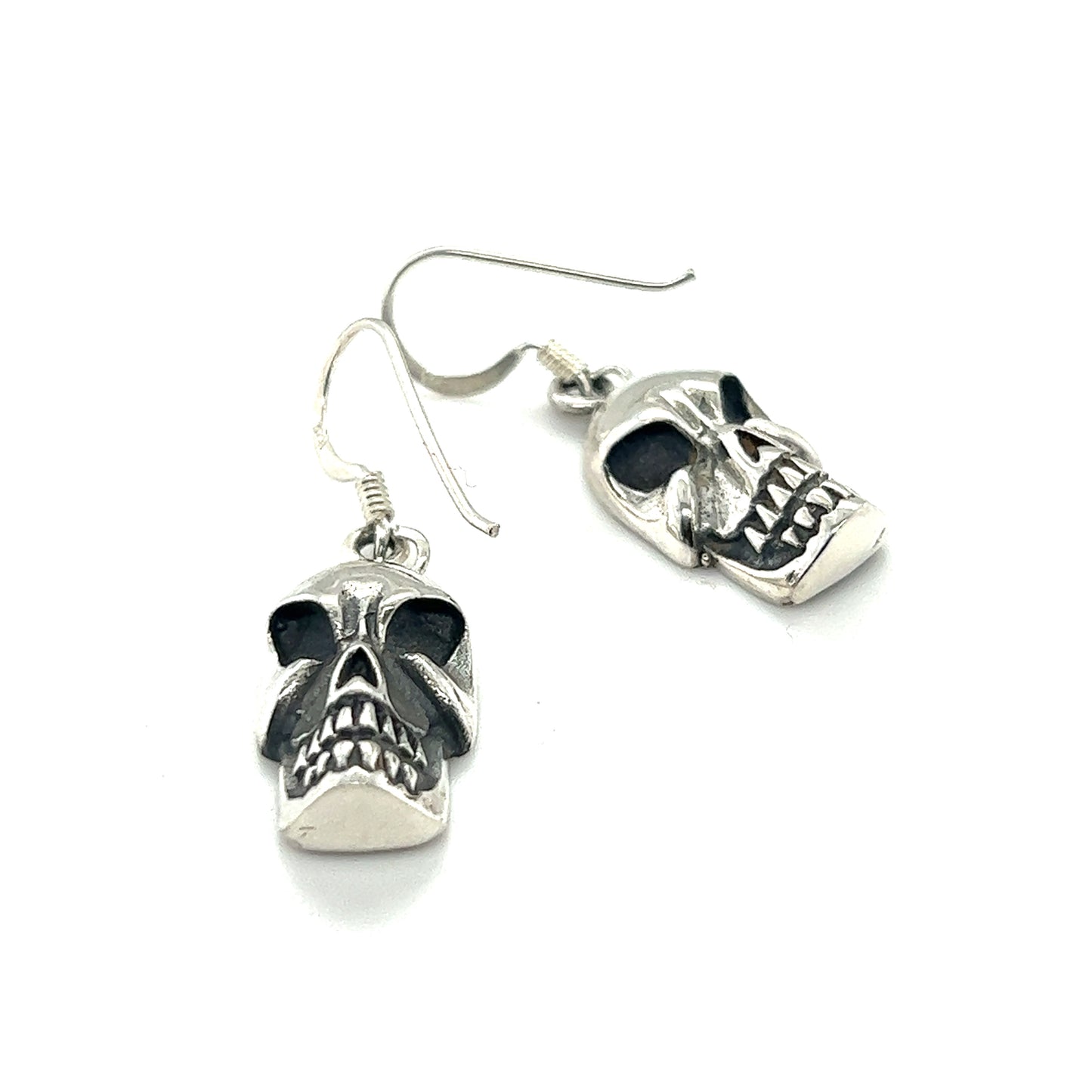 
                  
                    A pair of Super Silver Skull Earrings on a white background, exuding a macabre essence.
                  
                