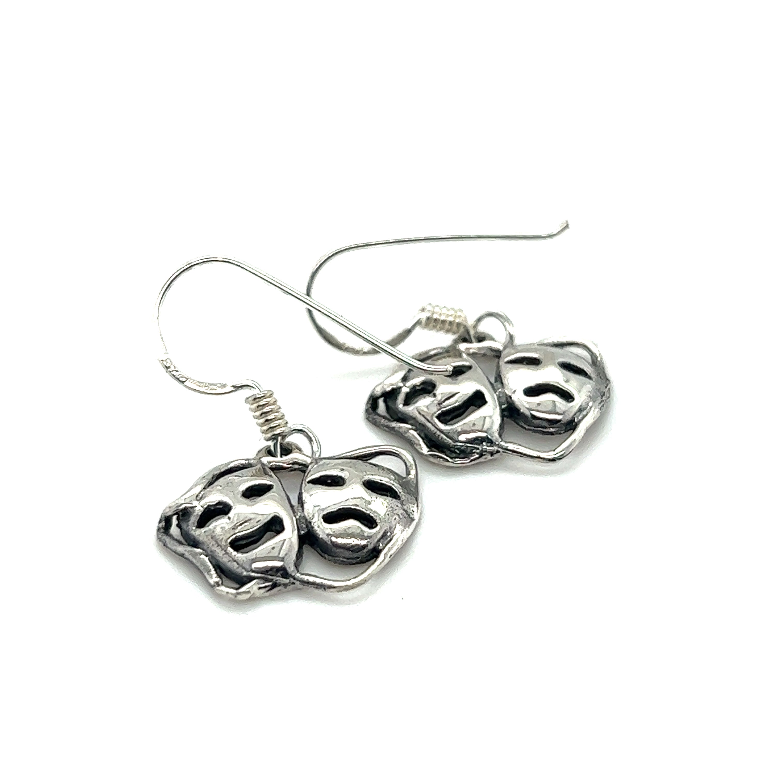 A stylish pair of Super Silver Smile Now Cry Later earrings featuring a minimalist design with two faces on them.