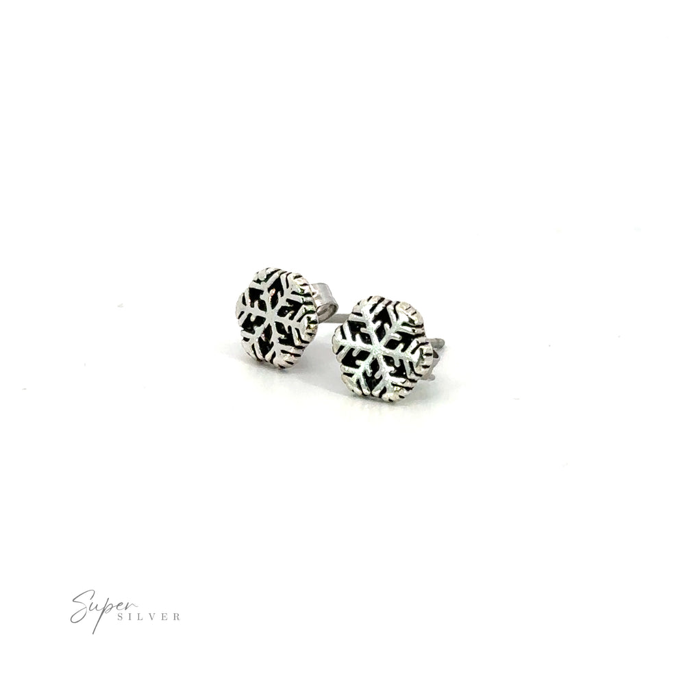A pair of silver Snowflake Studs with snowflake motifs.