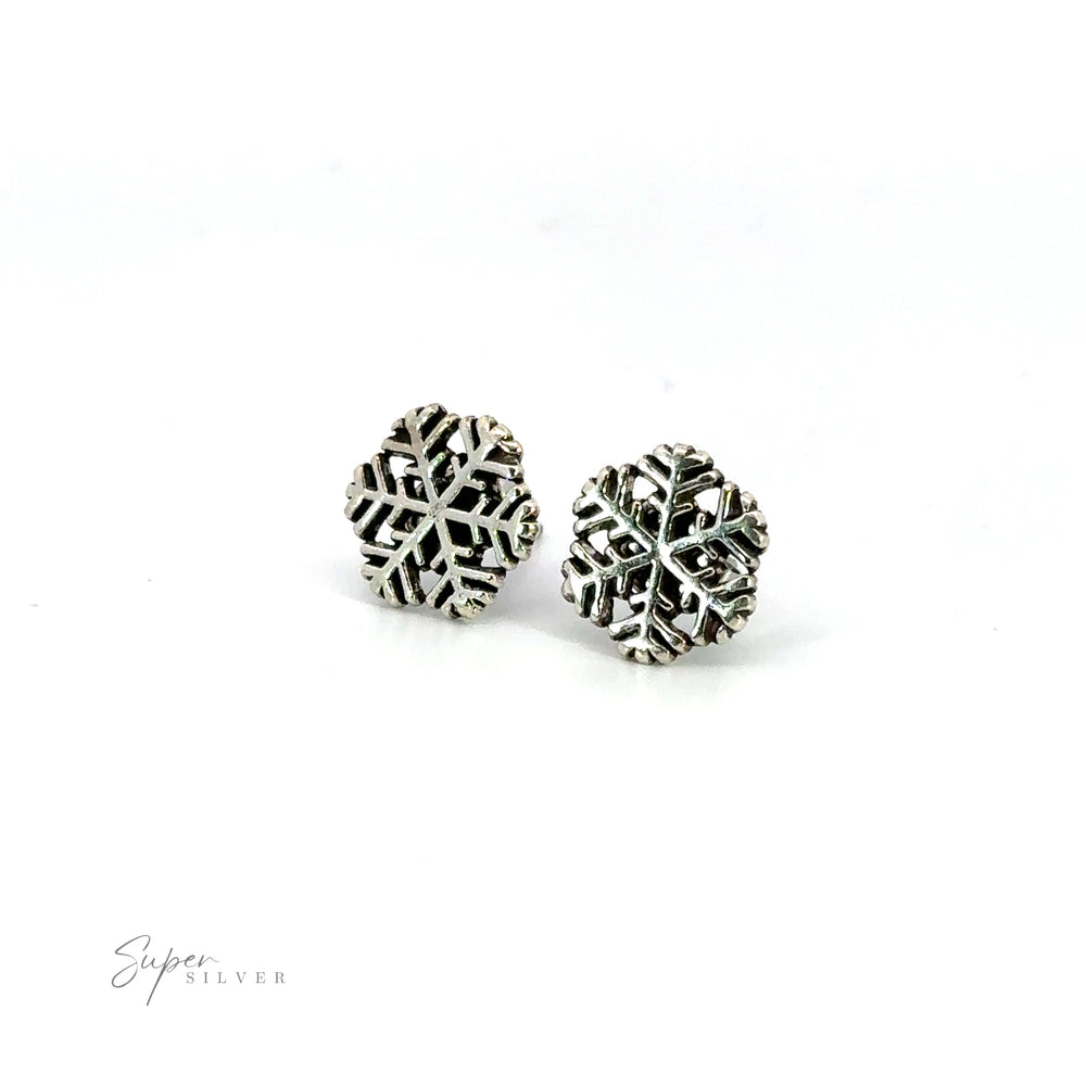 Embrace the winter wonder with these stunning Delicate Snowflake Studs. Shimmering in silver, they exude seasonal cheer.