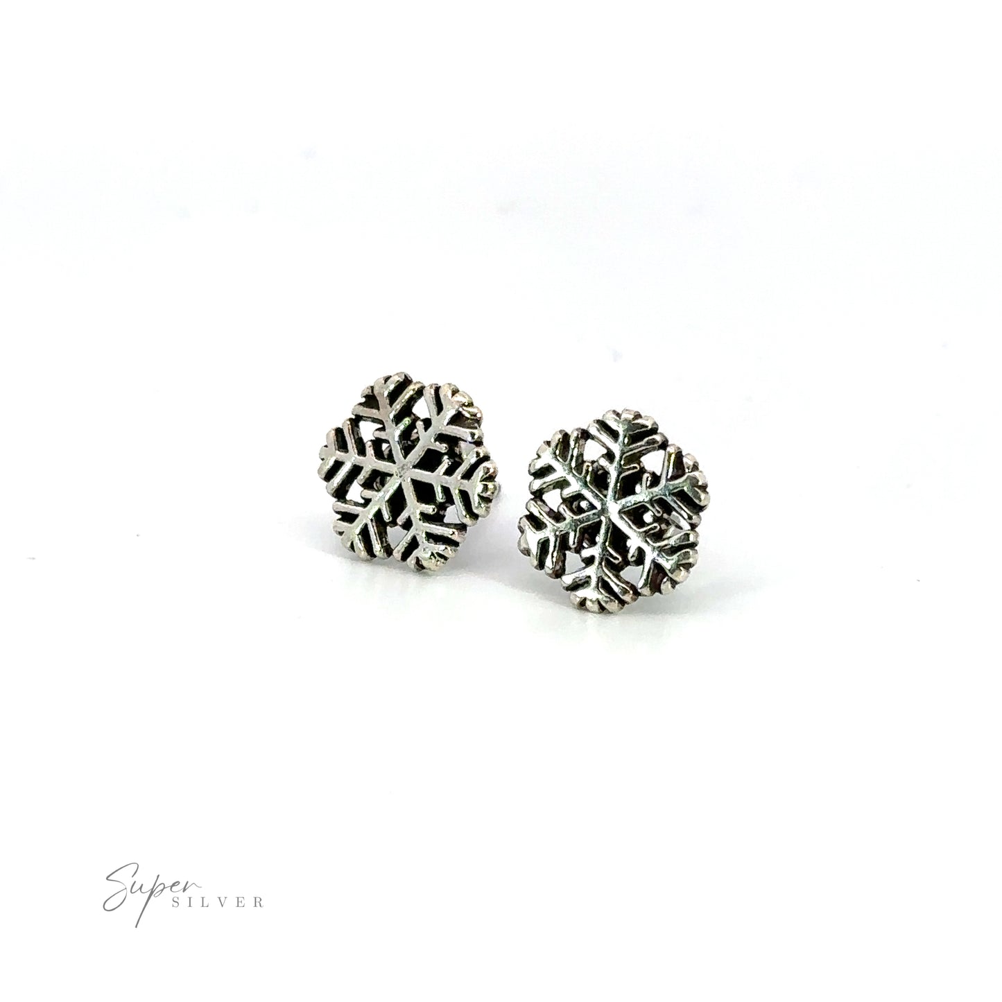 Embrace the winter wonder with these stunning Delicate Snowflake Studs. Shimmering in silver, they exude seasonal cheer.