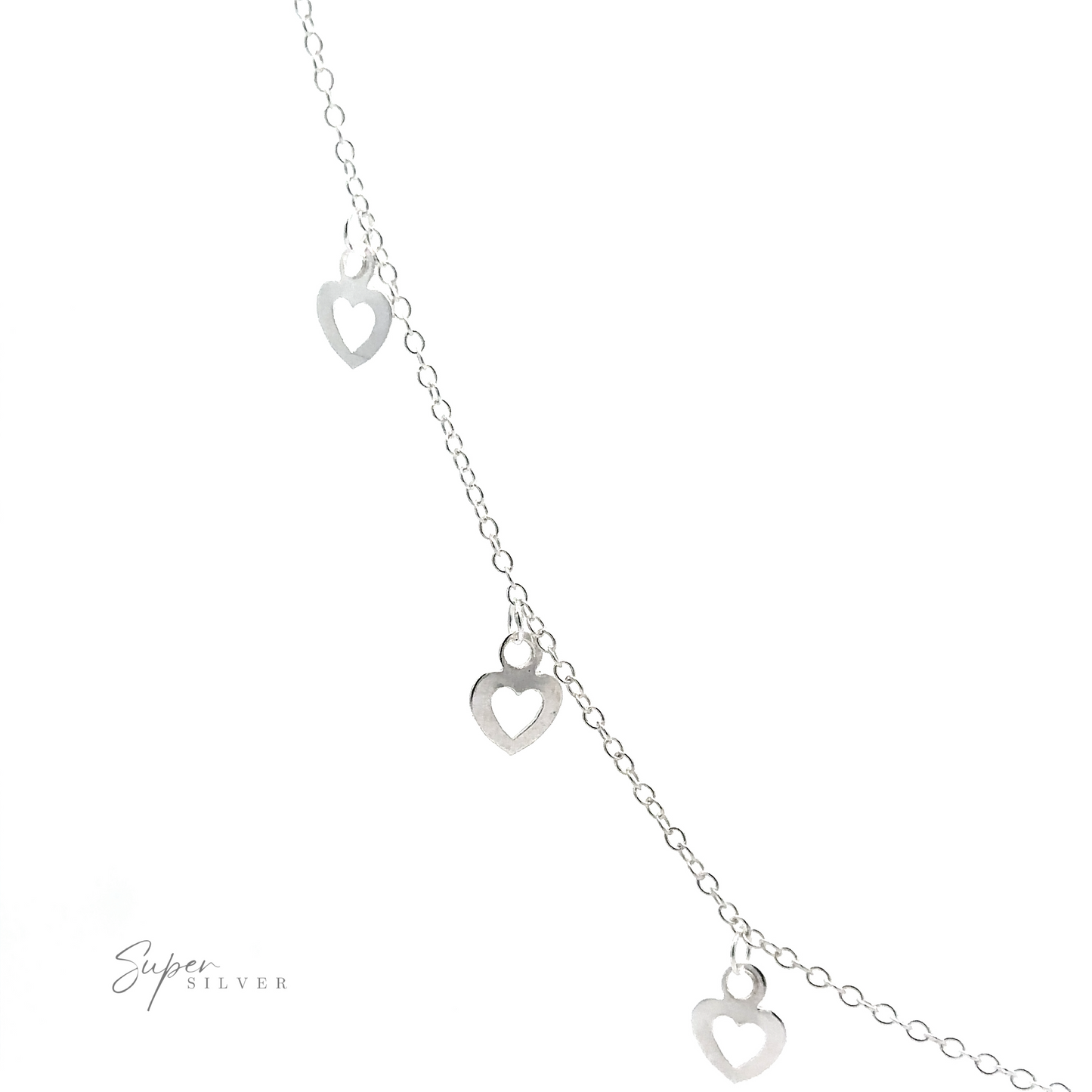 
                  
                    A delicate Silver Open Heart Charm Necklace featuring small open heart charms hanging from it. The name "Super Silver" is faintly visible in the bottom left corner.
                  
                