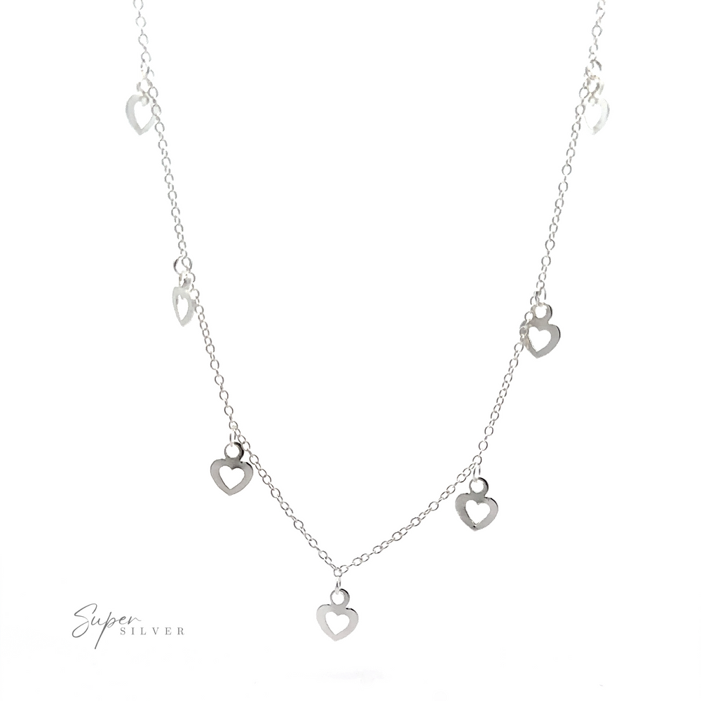 A Silver Open Heart Charm Necklace with small open heart charms evenly spaced along the chain.