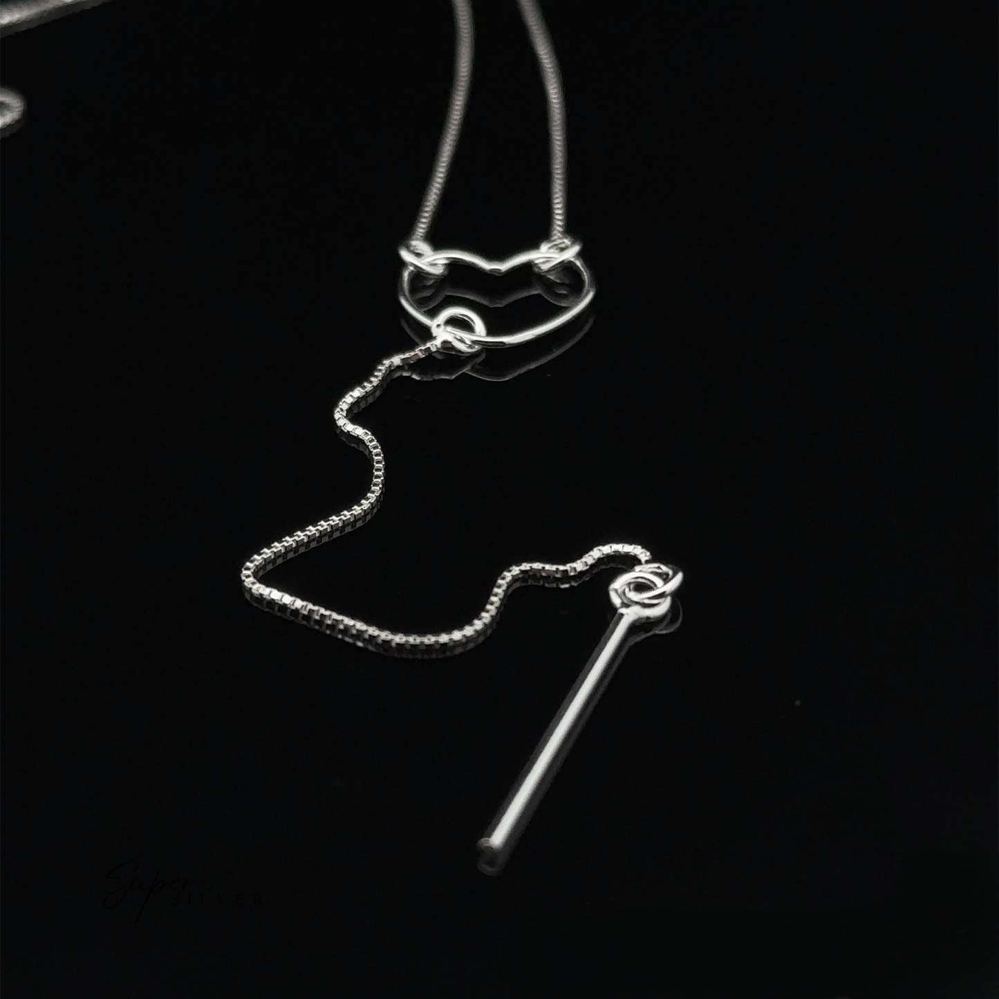 
                  
                    A stunning Open Heart Lariat Necklace, crafted from sterling silver, features a heart and bar pendant displayed elegantly against a black background.
                  
                