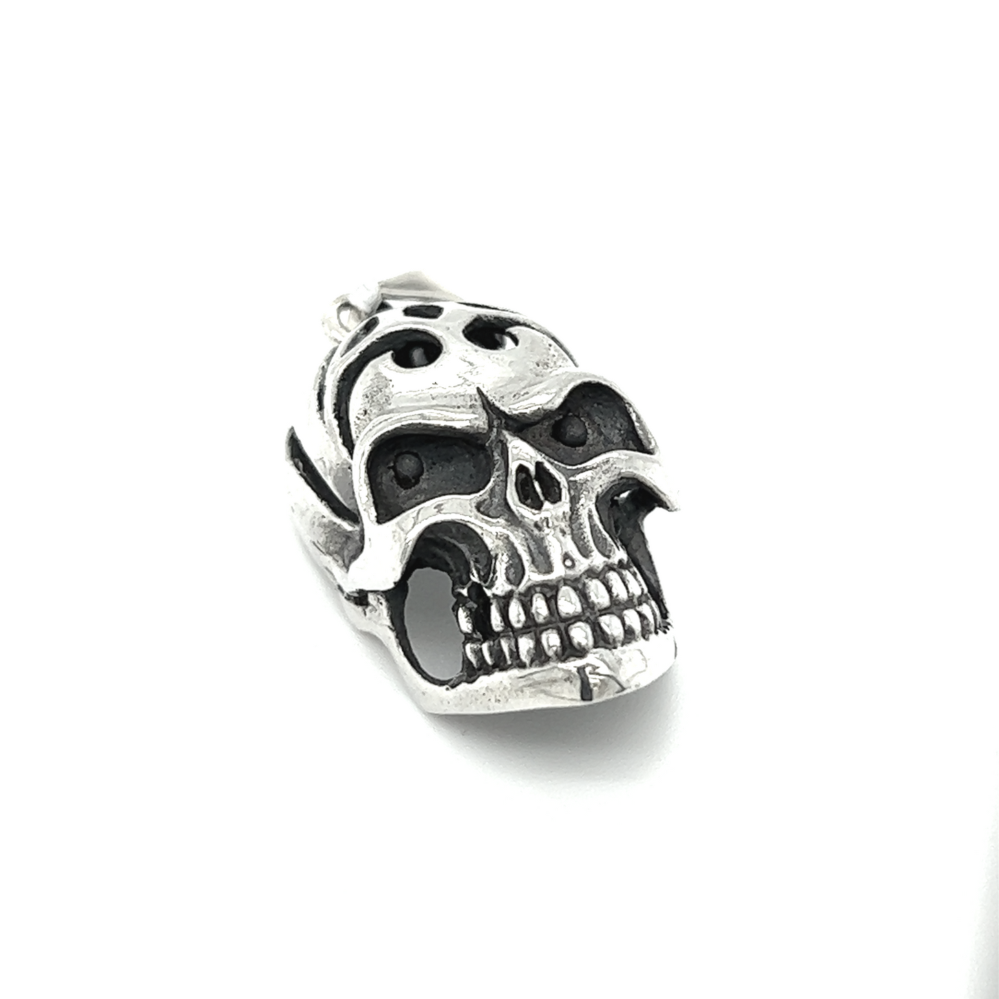 A distinctive Super Silver skull pendant with an oxidized finish on a white background.