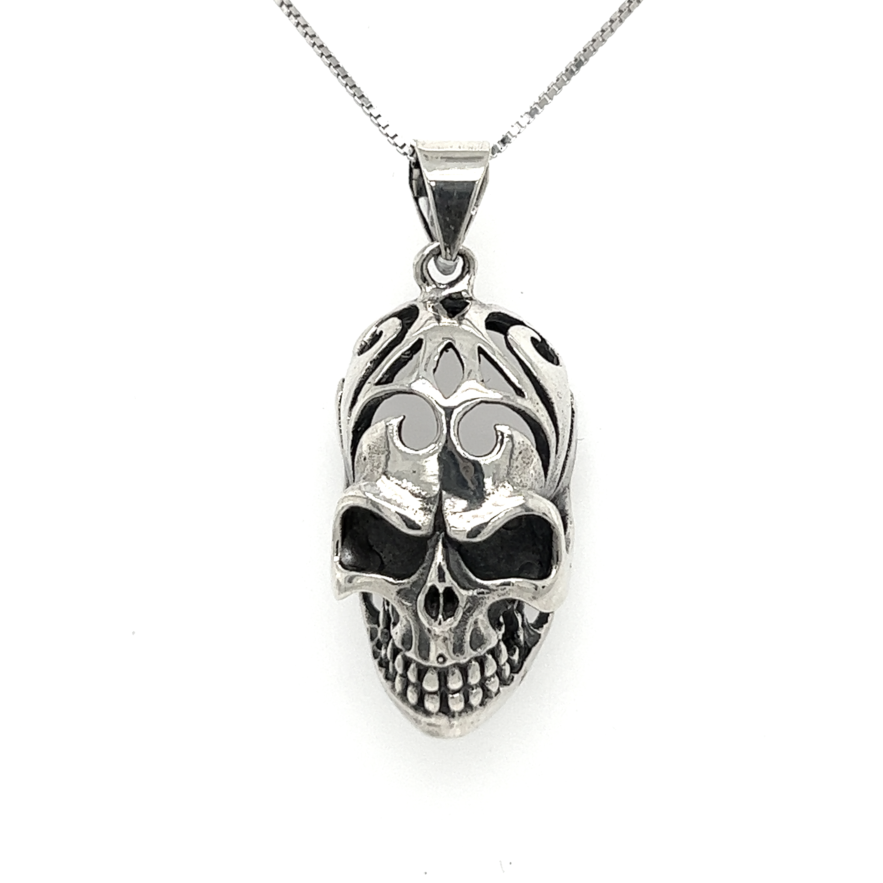 A Super Silver Skull Pendant with Swirl Design on a chain.