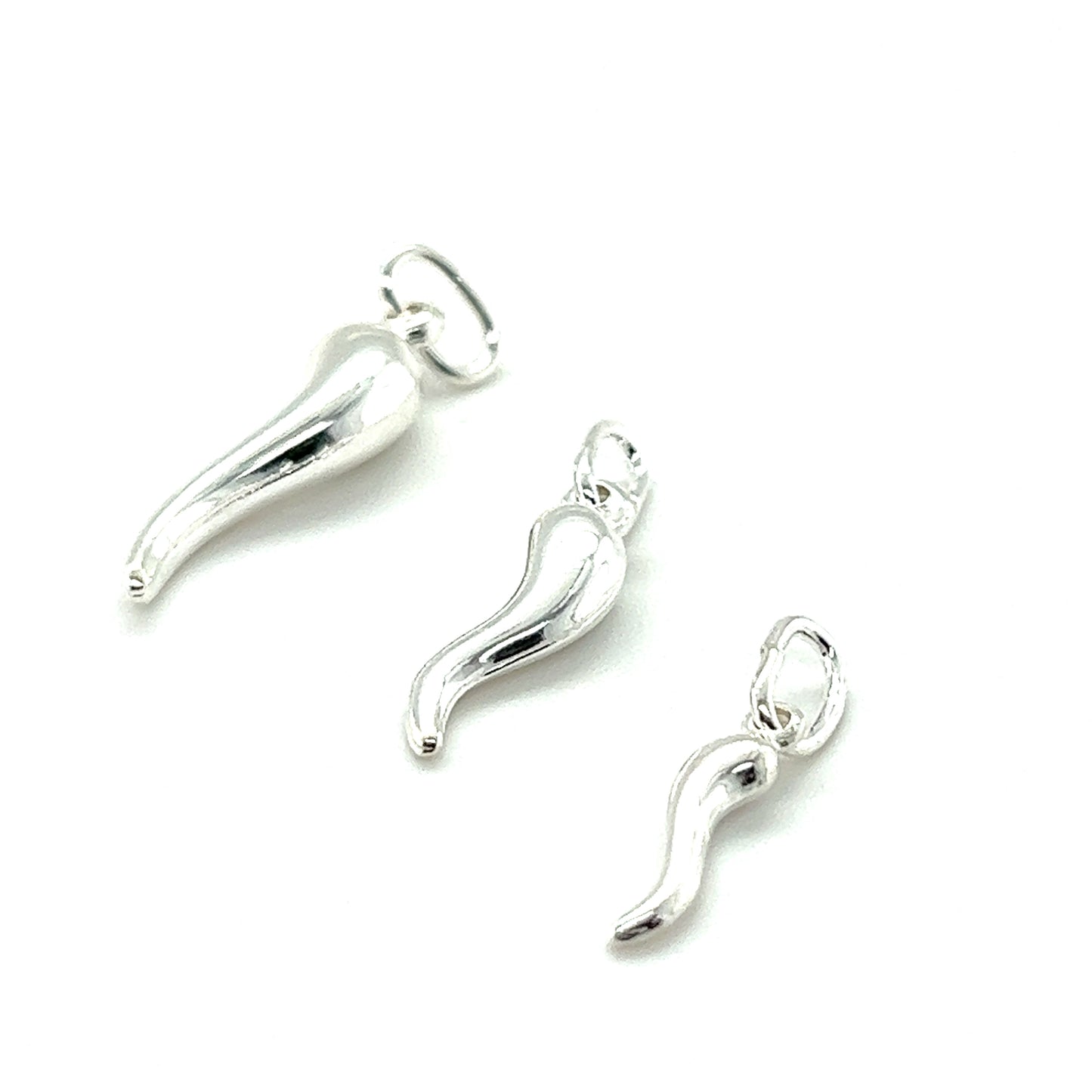 
                  
                    Three Super Silver Italian Horn Charms on a white surface, perfect for a charm collection and symbolizing good fortune.
                  
                