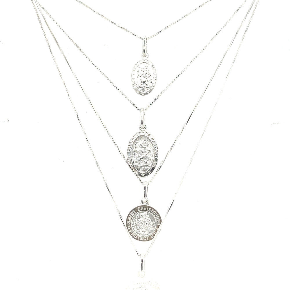 
                  
                    A Super Silver necklace featuring the Saint Christopher Medallion In Various Sizes, depicting three coins.
                  
                