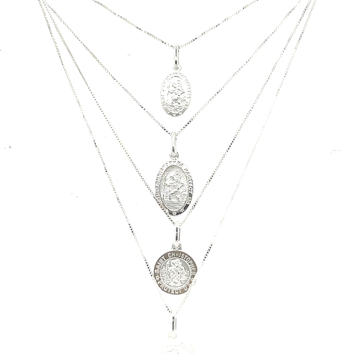
                  
                    A Super Silver necklace featuring the Saint Christopher Medallion In Various Sizes, depicting three coins.
                  
                